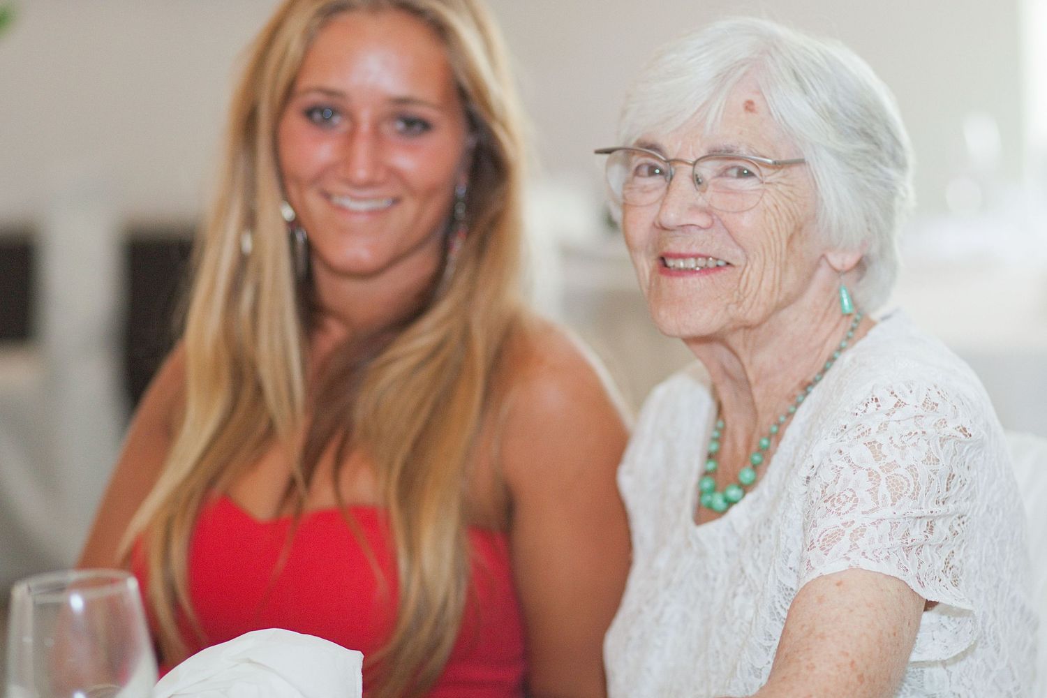 Wedding guests in bright summer attire share joyful moments during the celebration.