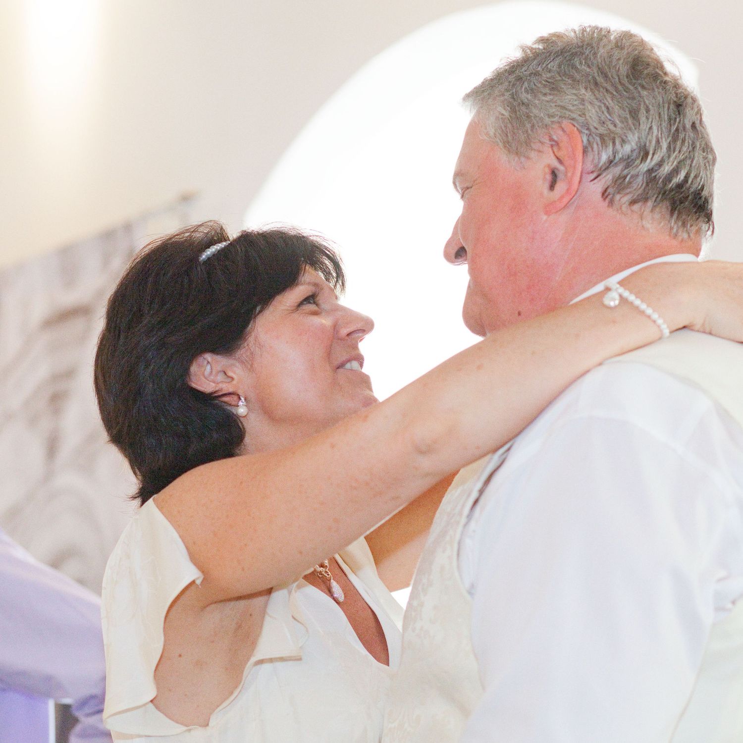 A couple shares an intimate dance moment at their wedding celebration.