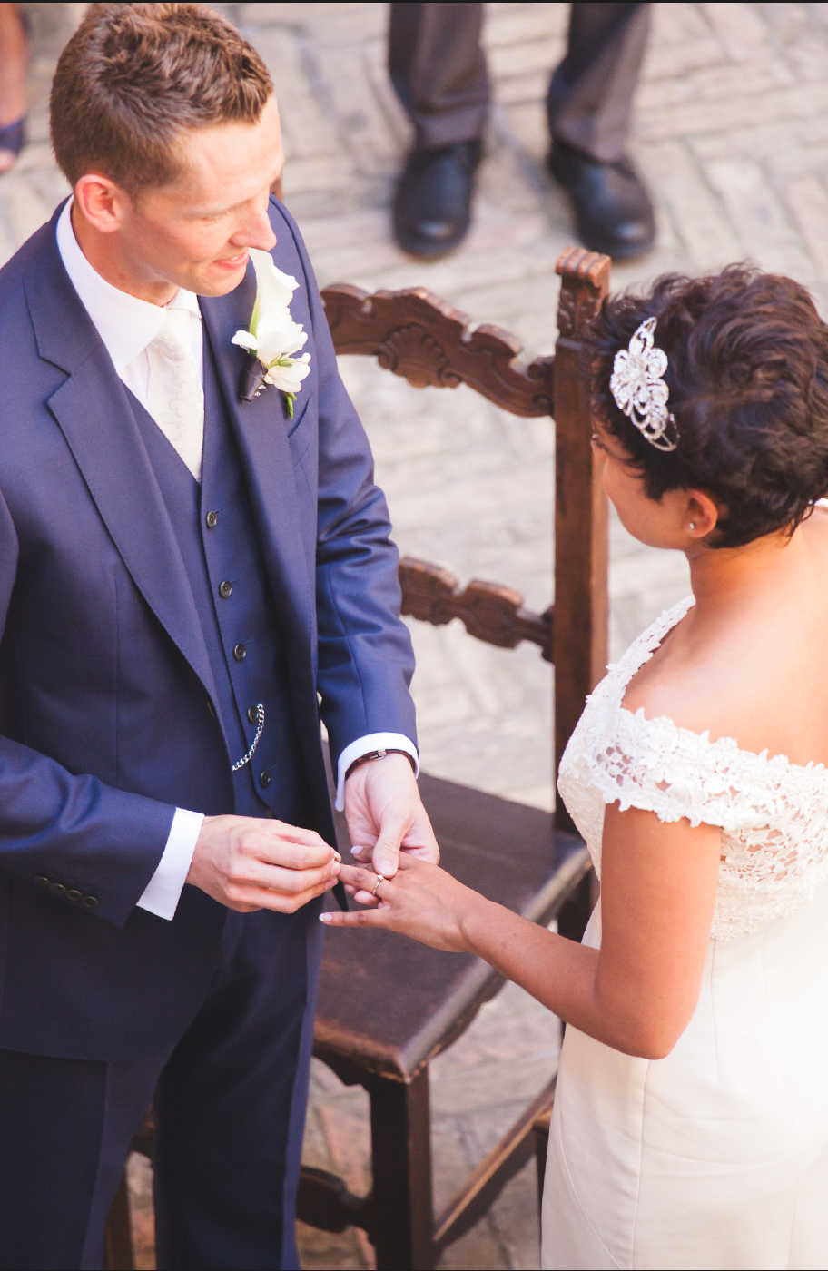 A couple shares an intimate moment during their ring exchange at their wedding ceremony.