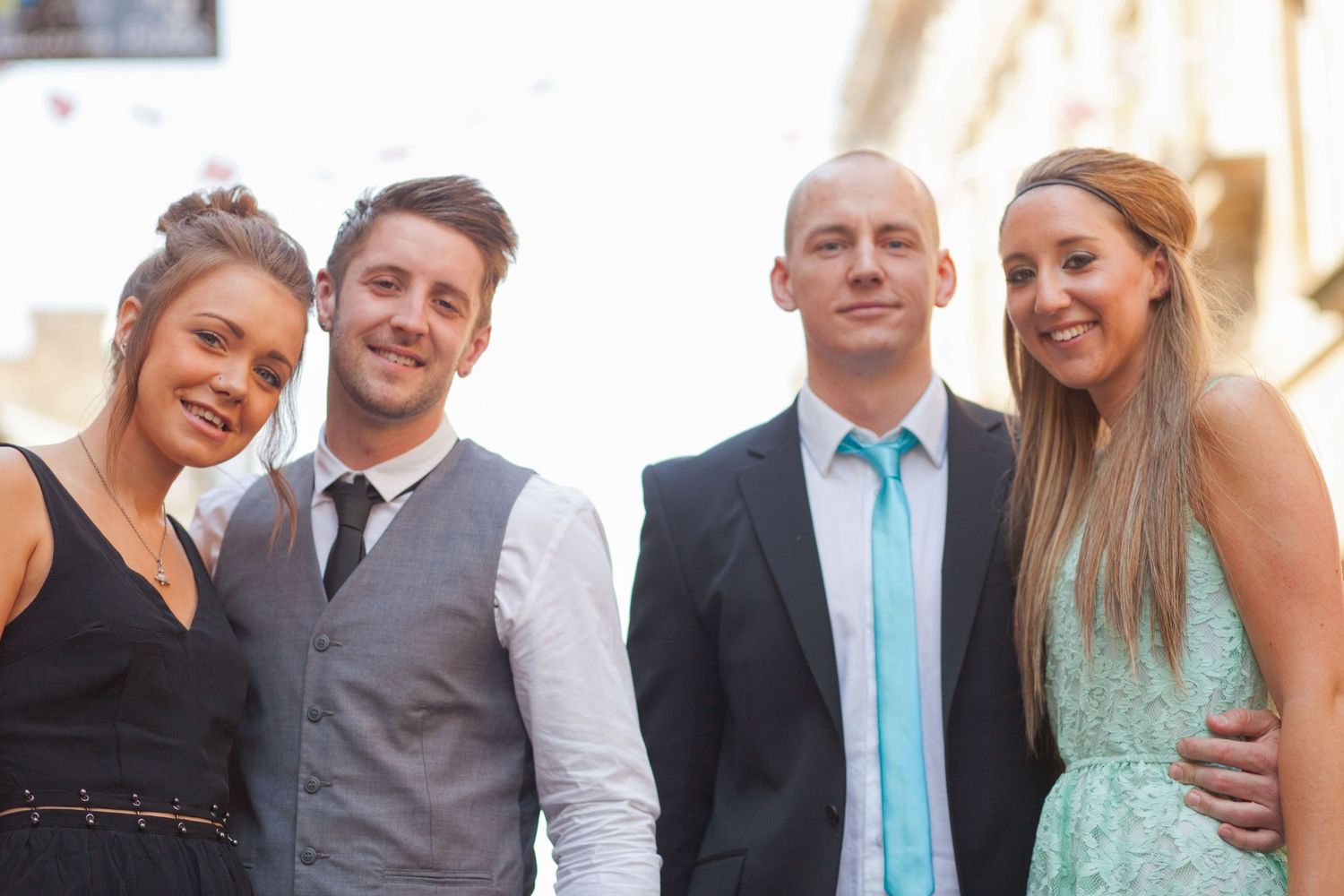Formal group photo of wedding party members in coordinated attire.