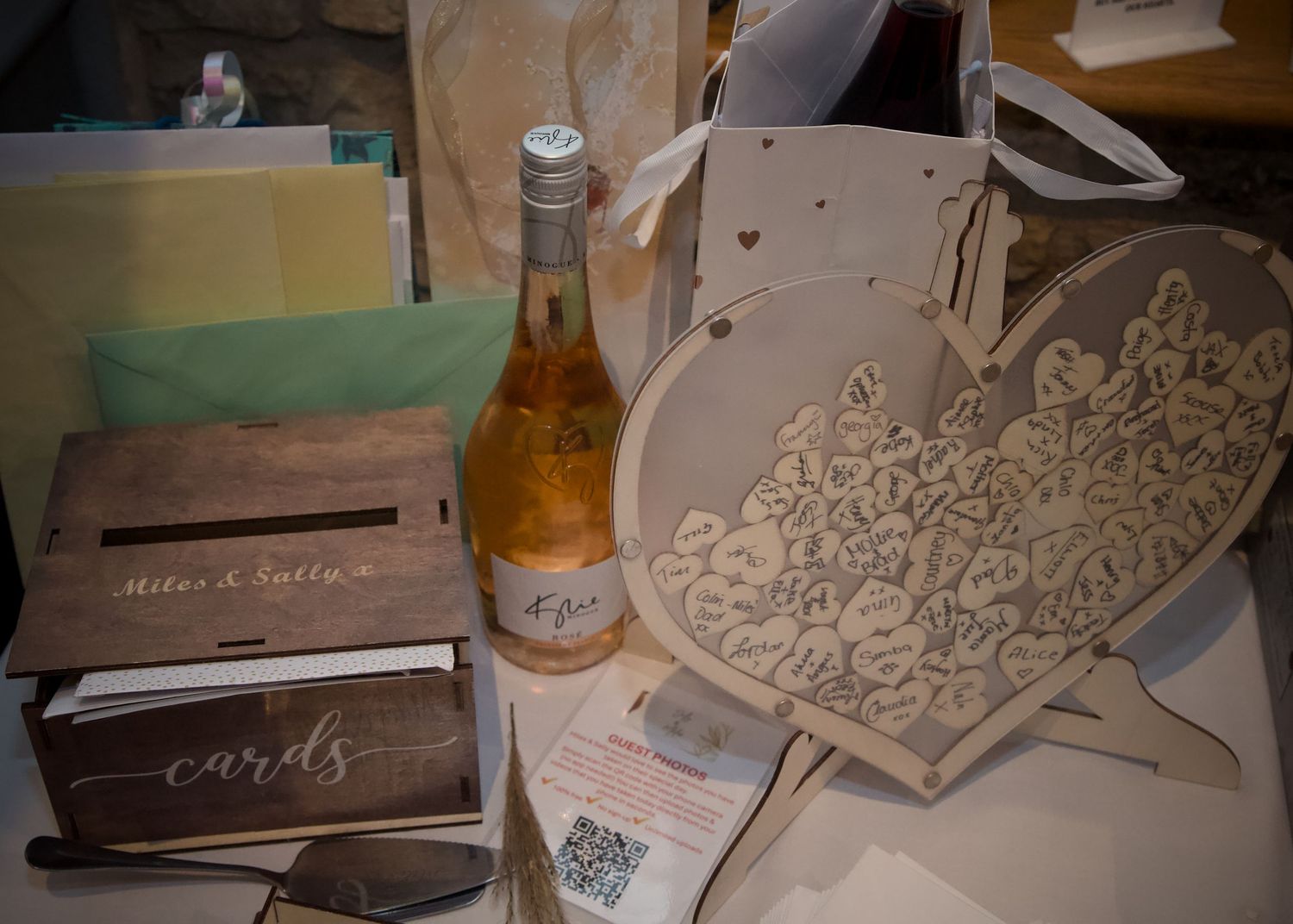 Rustic wedding decor featuring wooden signs and laser-cut details on display at reception.
