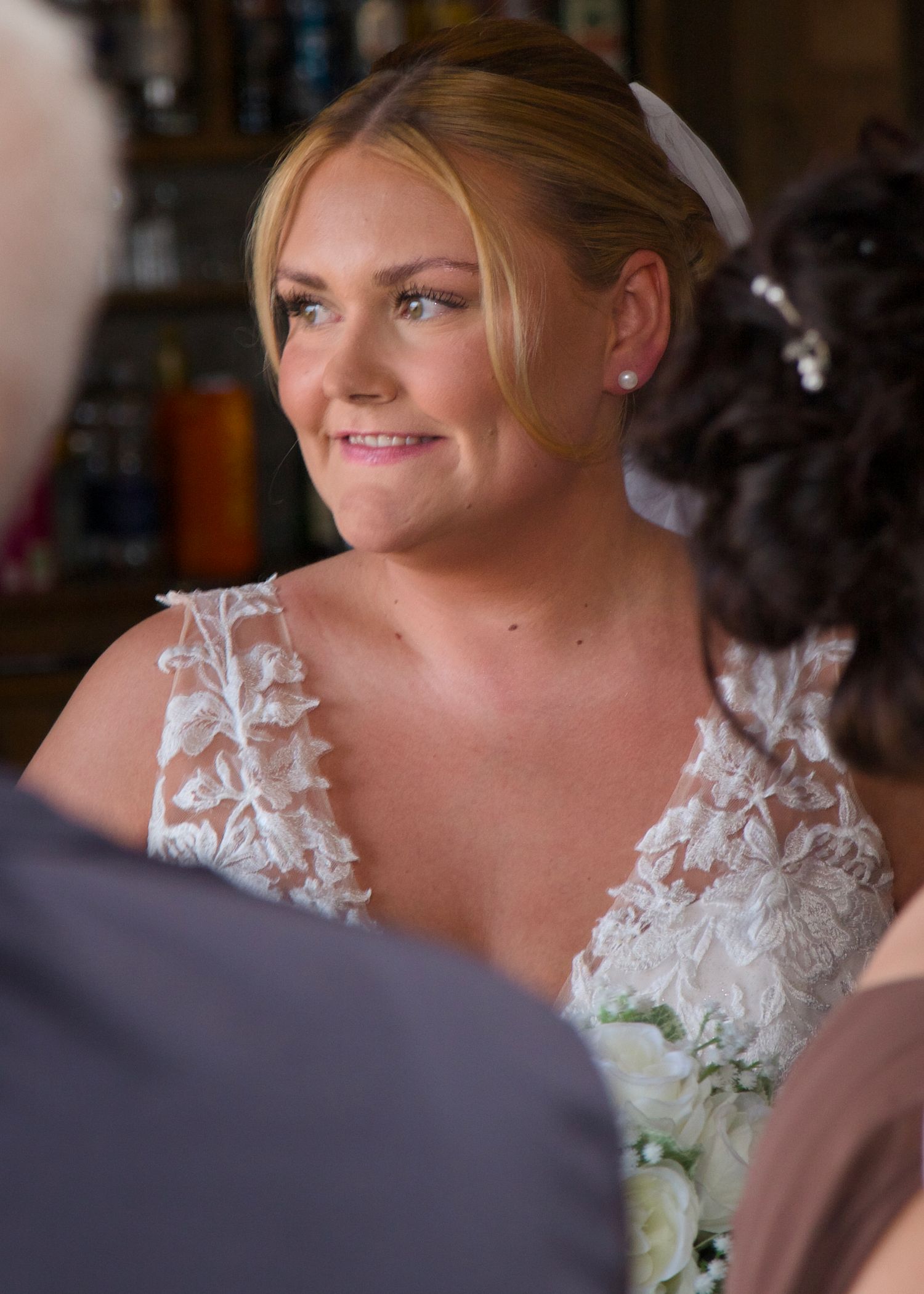 Close-up shot of lace detail on a white wedding dress.