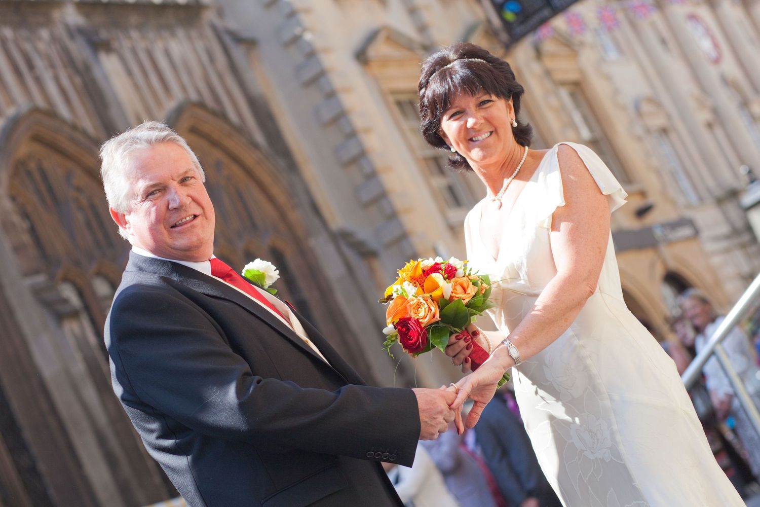 Series of candid wedding moments captured along historic stone buildings and street lamps.