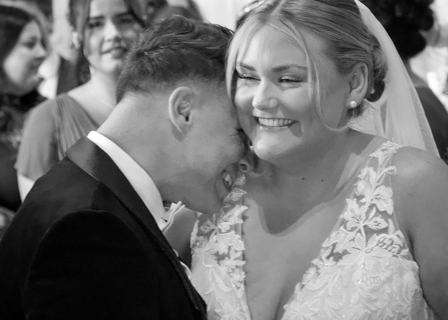 Emotional wedding ceremony moments captured in black and white photography.