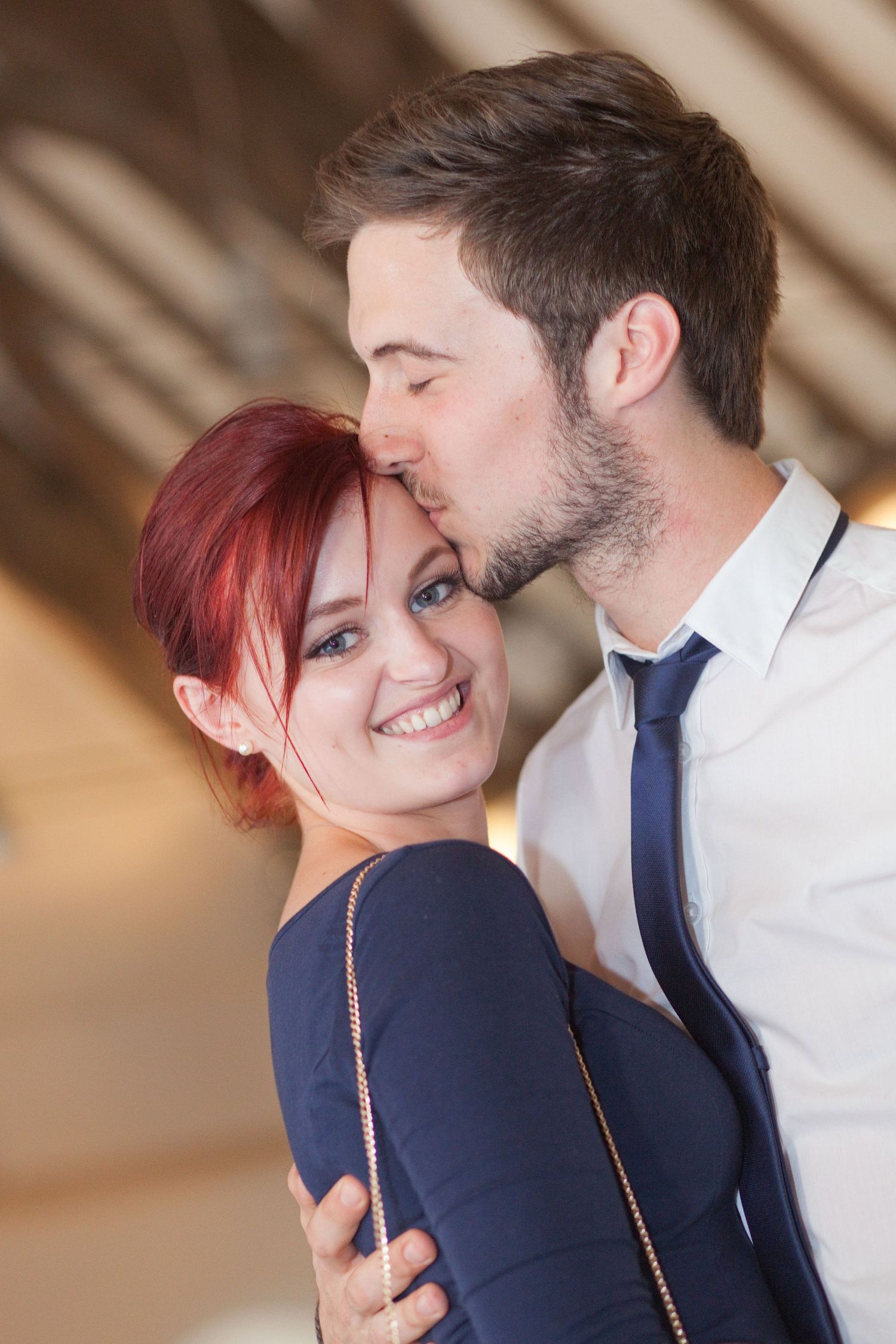 Intimate couple portrait showing affection against neutral background.