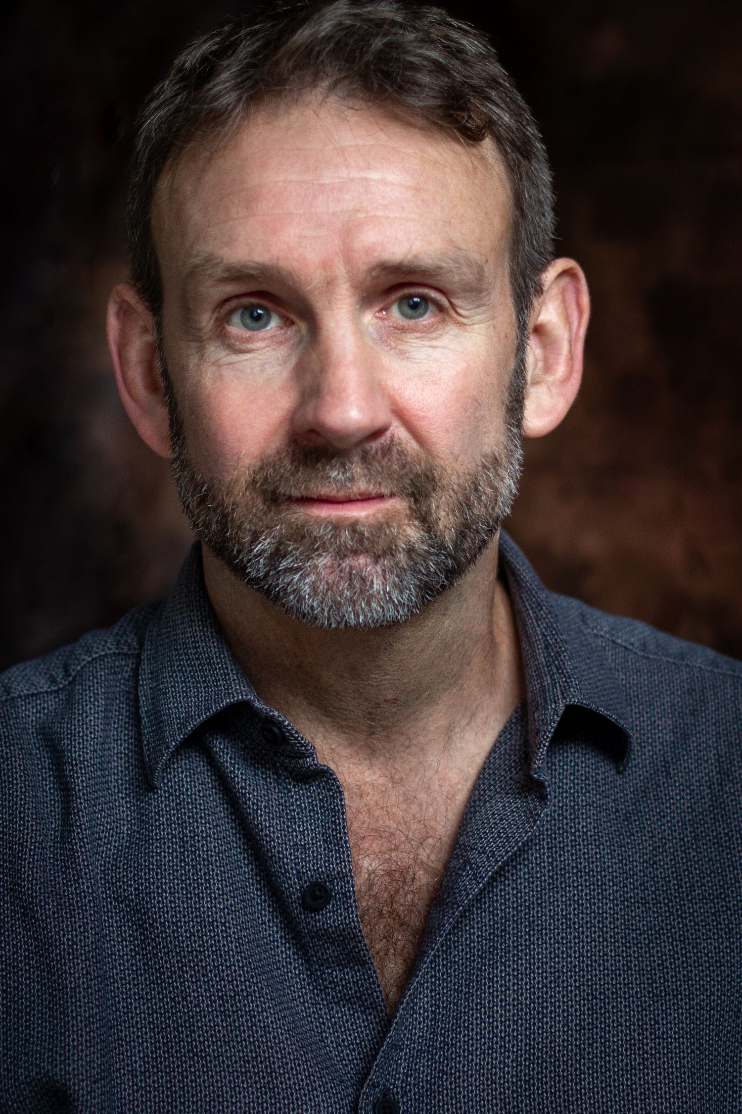 Series of dramatic portraits showing different expressions in low key lighting.
