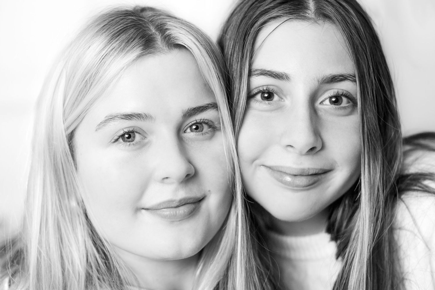 A black and white photo collage shows multiple close-up portraits arranged in a horizontal row.