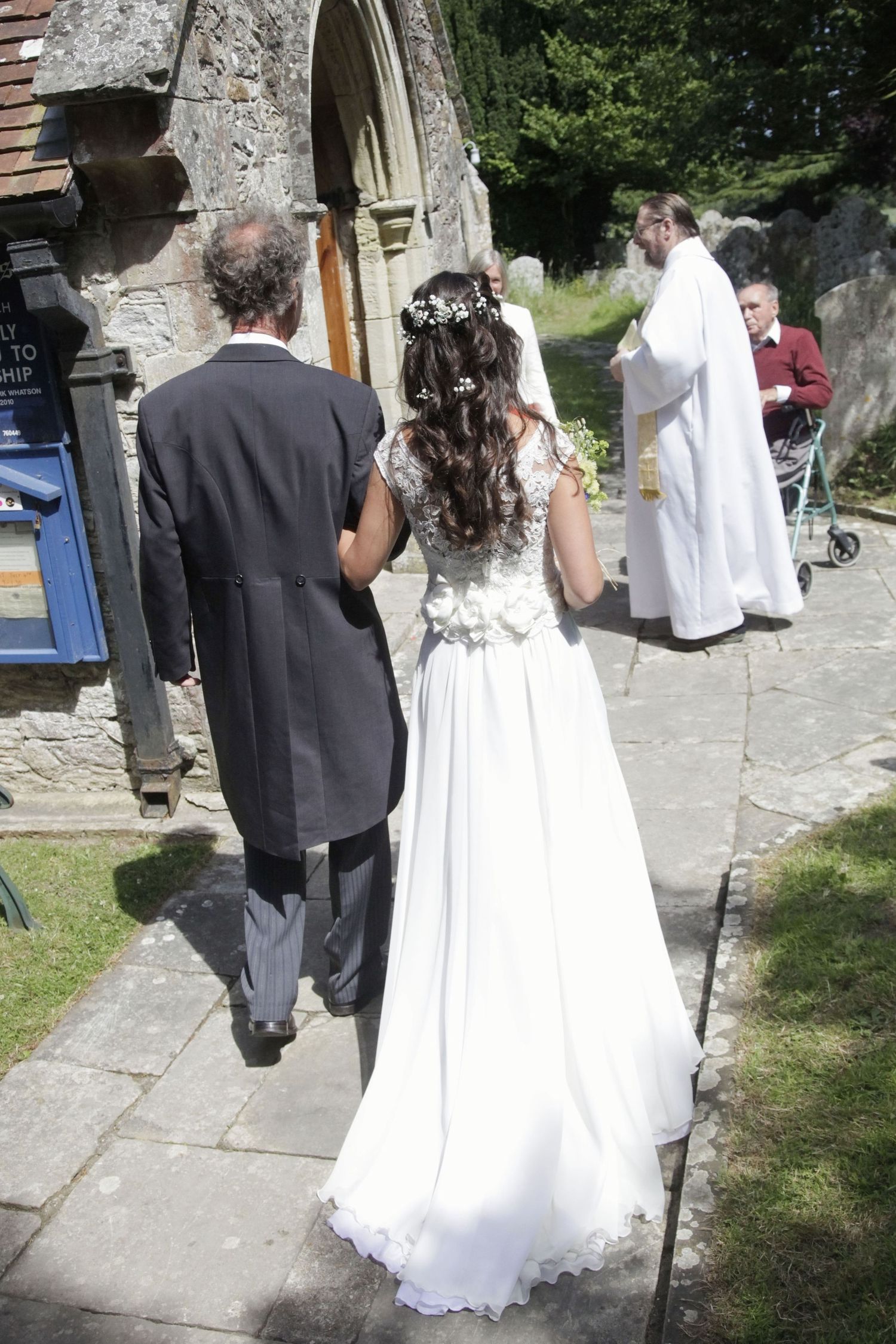 Wedding ceremony entrance with stone archway and traditional church architecture.