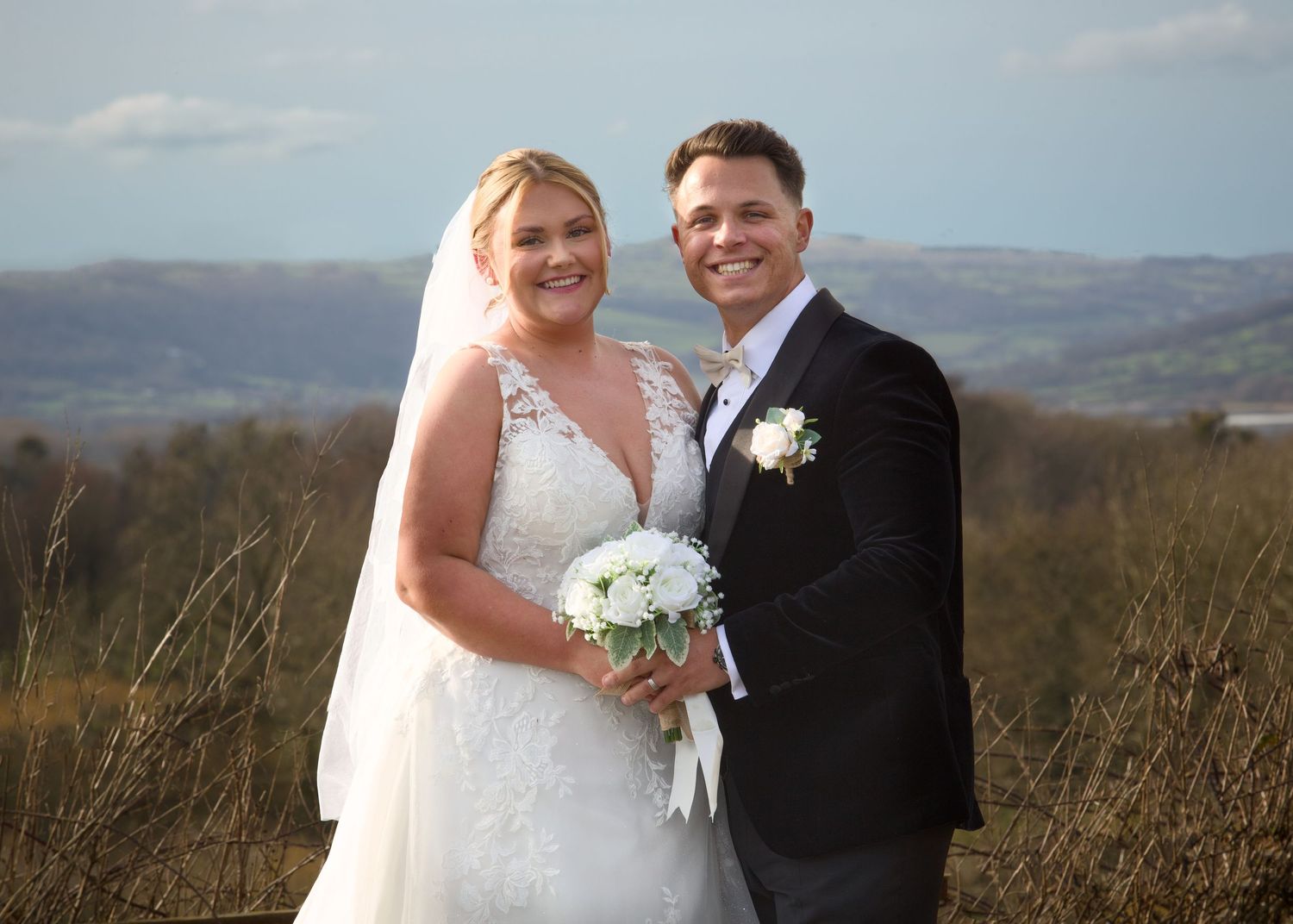 Wedding portraits with scenic mountain landscape in background.