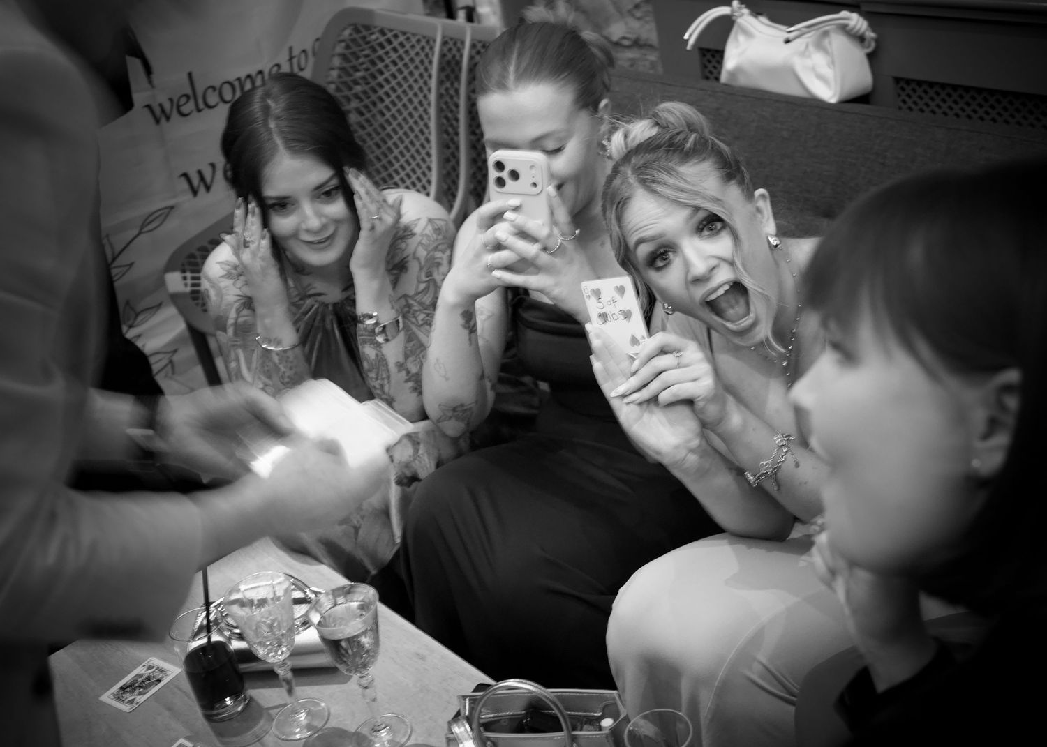 Black and white candid shots of wedding guests enjoying the celebration.
