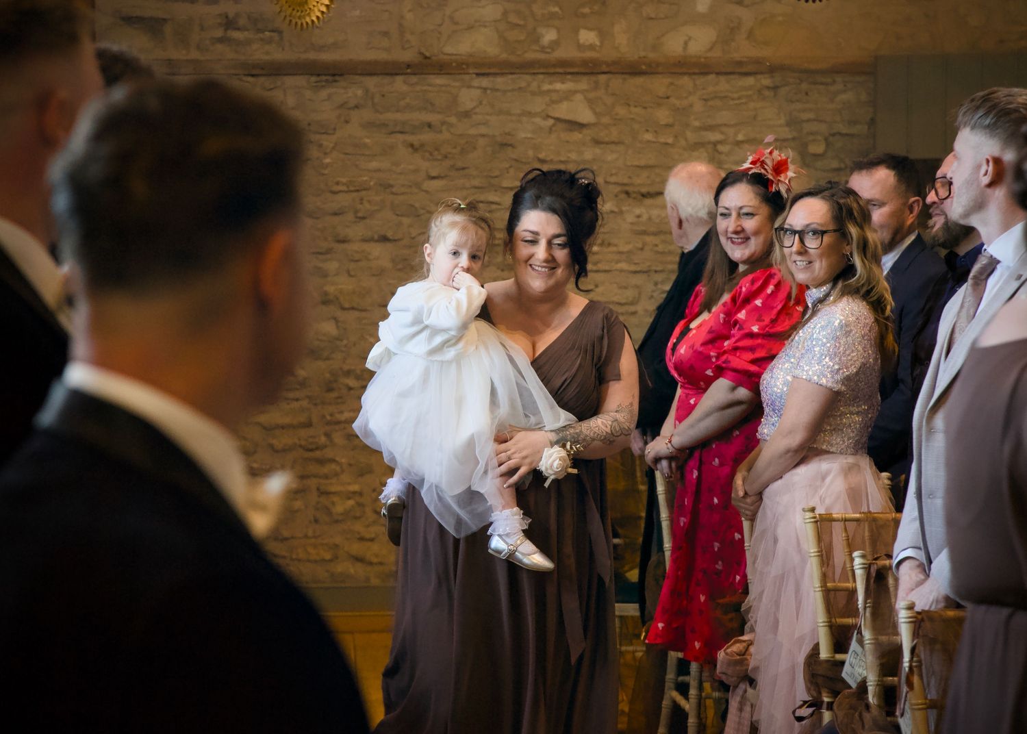 Wedding guests gathered in a rustic brick venue during the celebration.