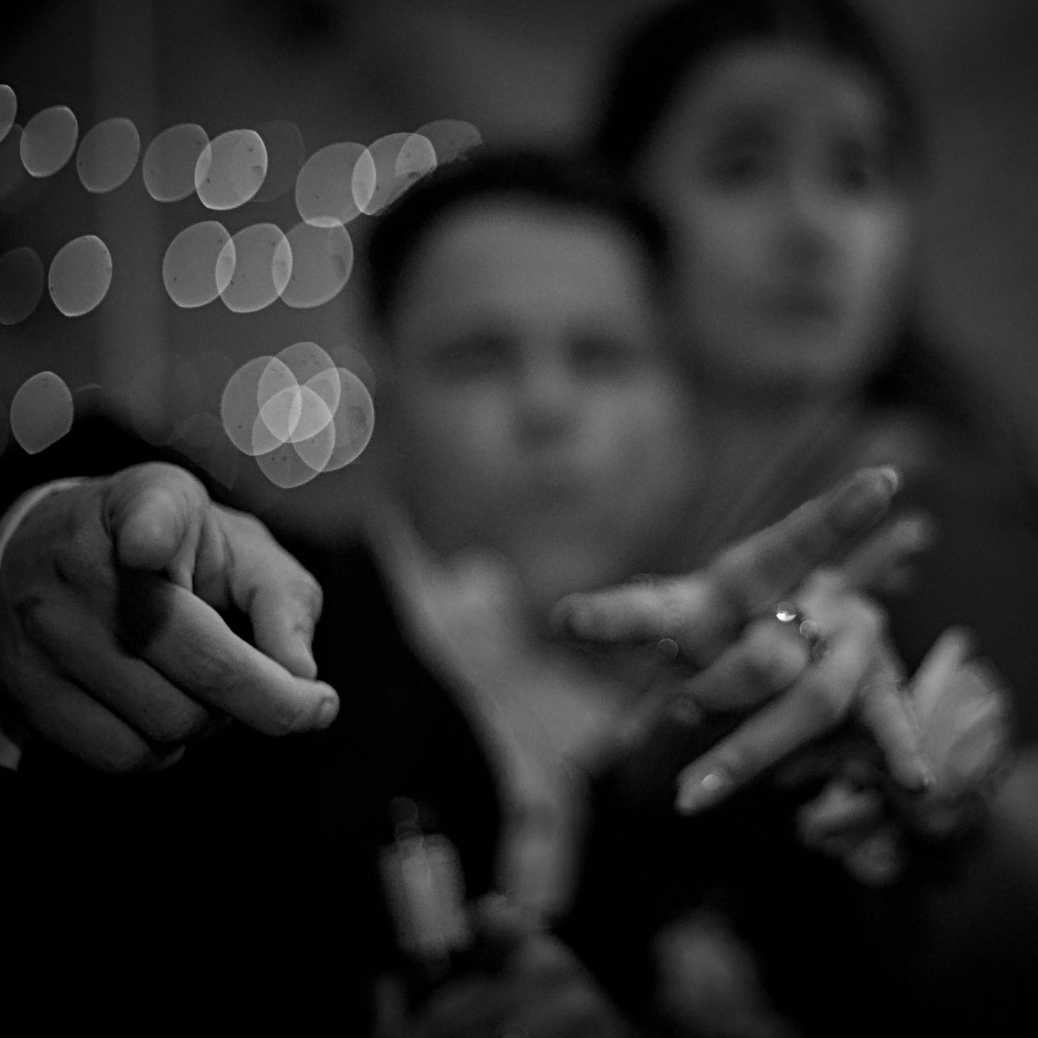 Abstract black and white bokeh lights creating a dreamy background effect.