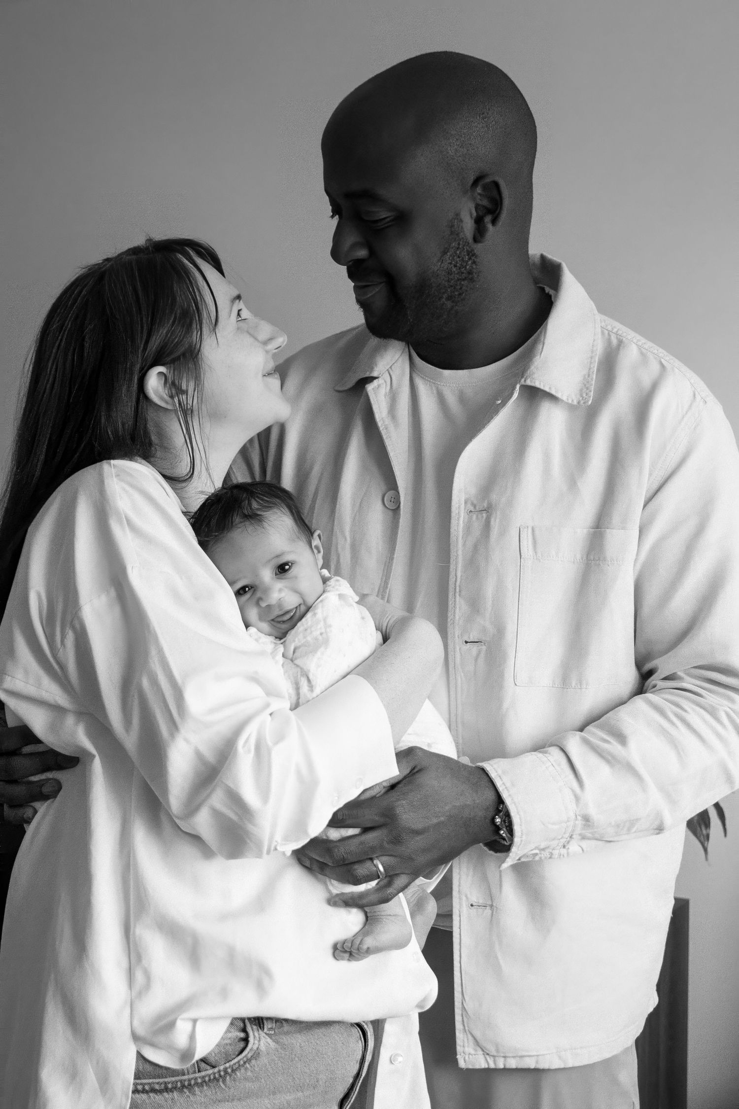 Series of tender family moments captured in black and white with parents and baby.