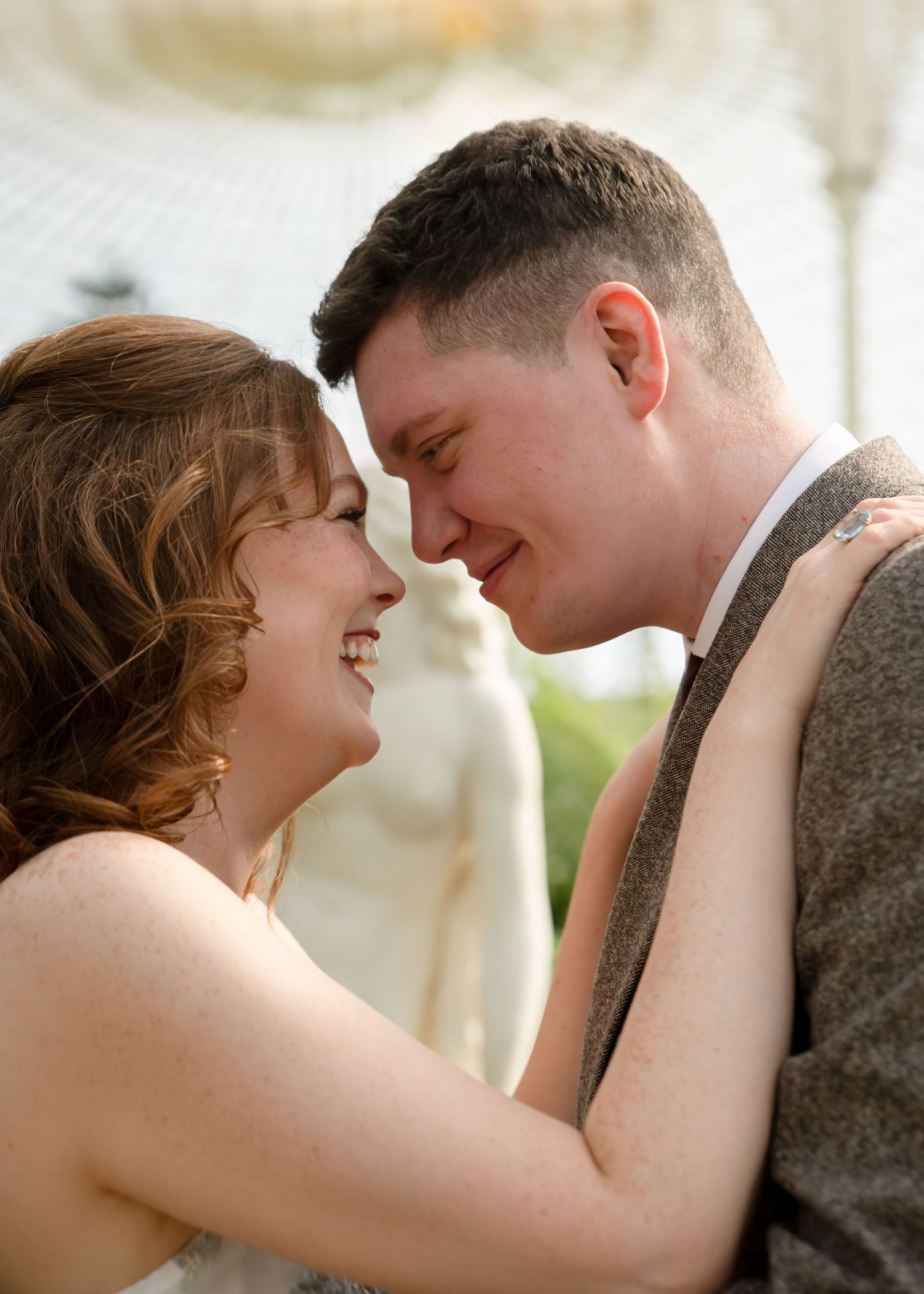 Romantic couple sharing intimate close-up moments in soft natural lighting.
