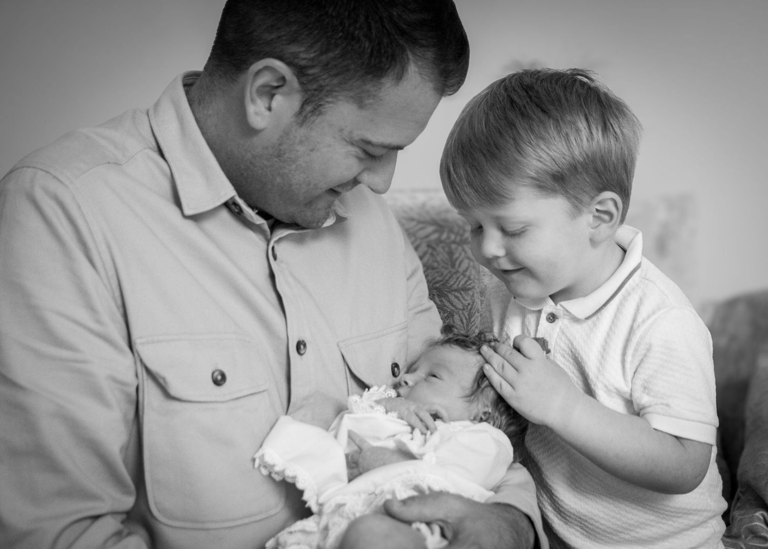Black and white series of tender family moments with a small baby.