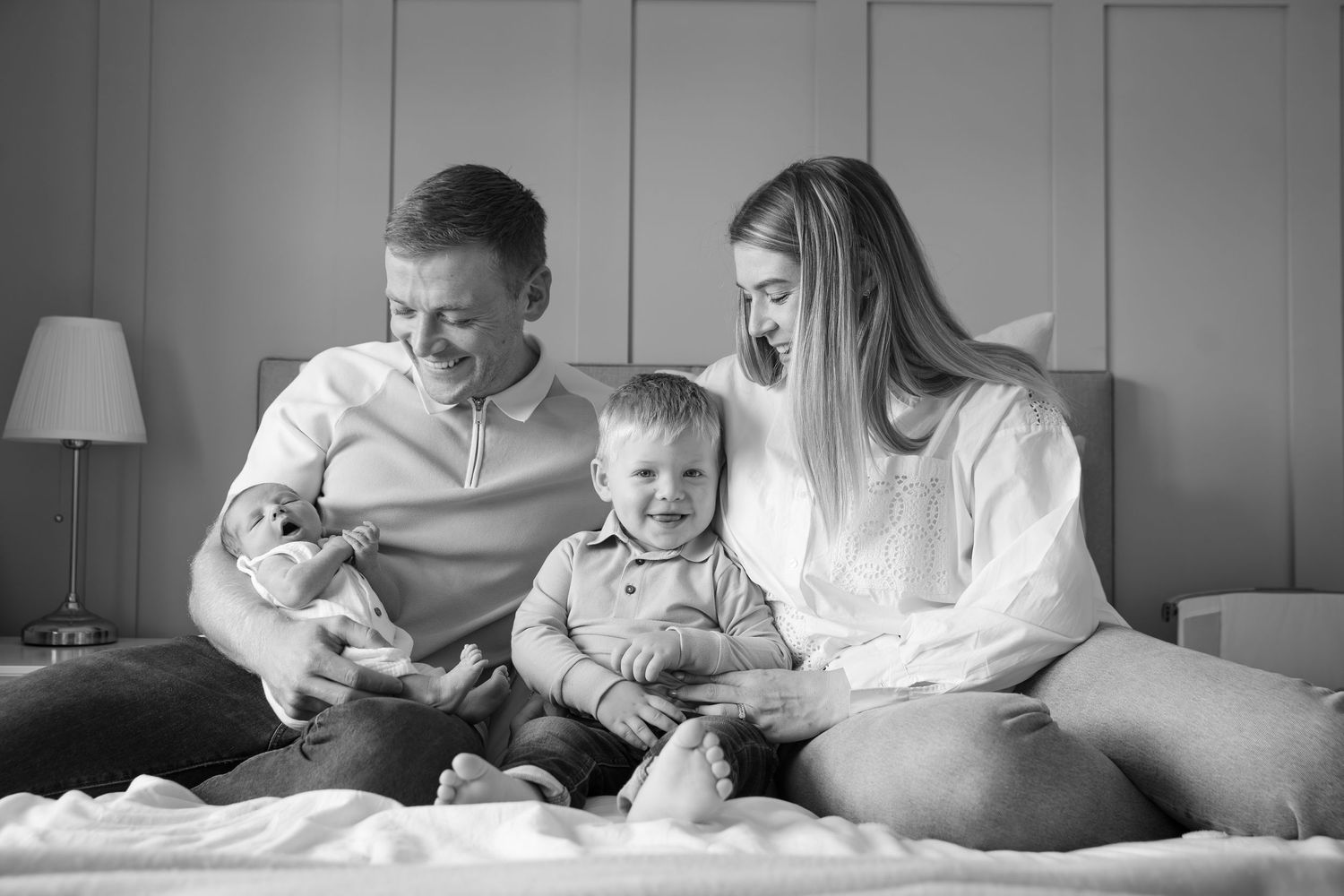 Family spending quality time together reading and bonding on a bed.