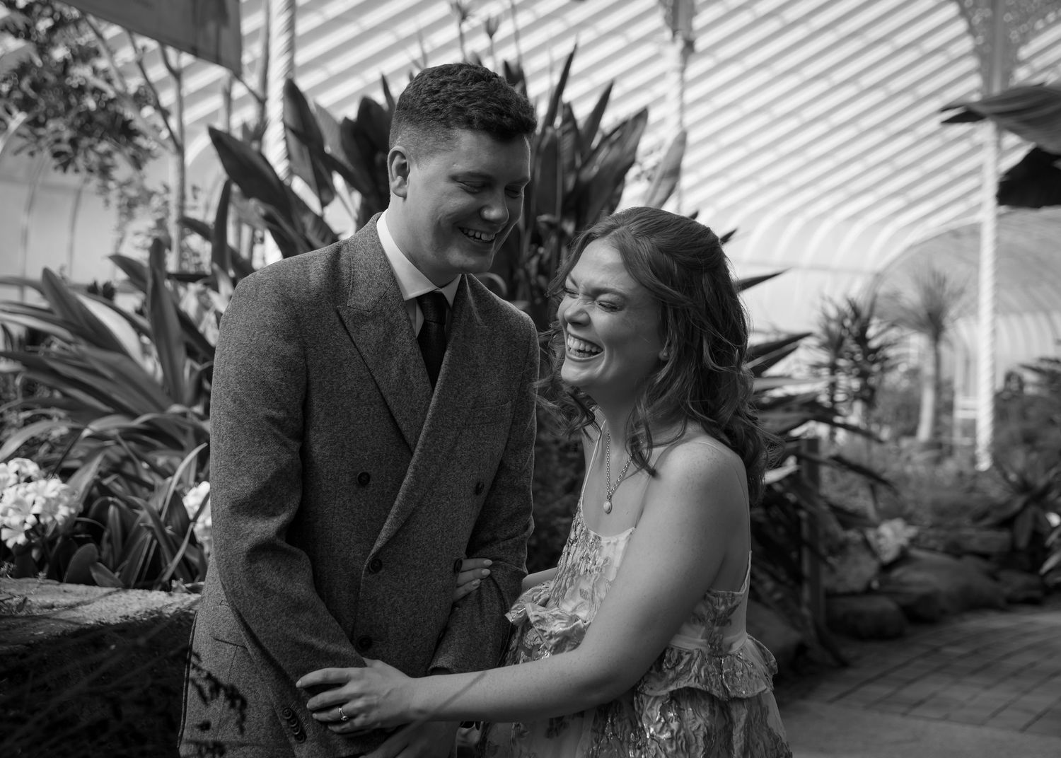 Candid engagement photo series showing couple laughing together in natural light.