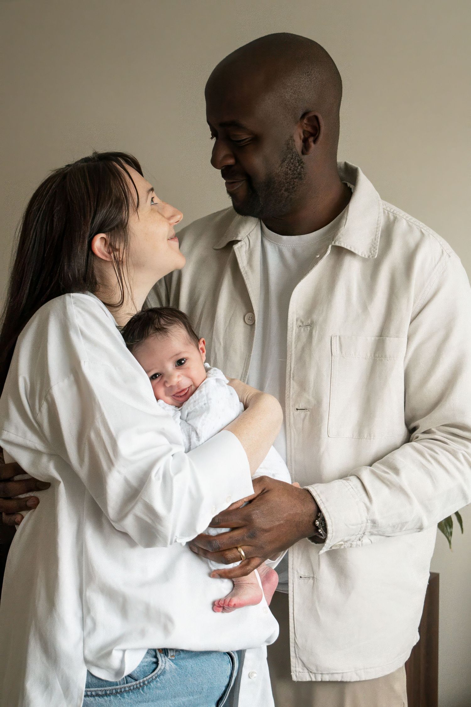 A tender family moment captured against a neutral background.