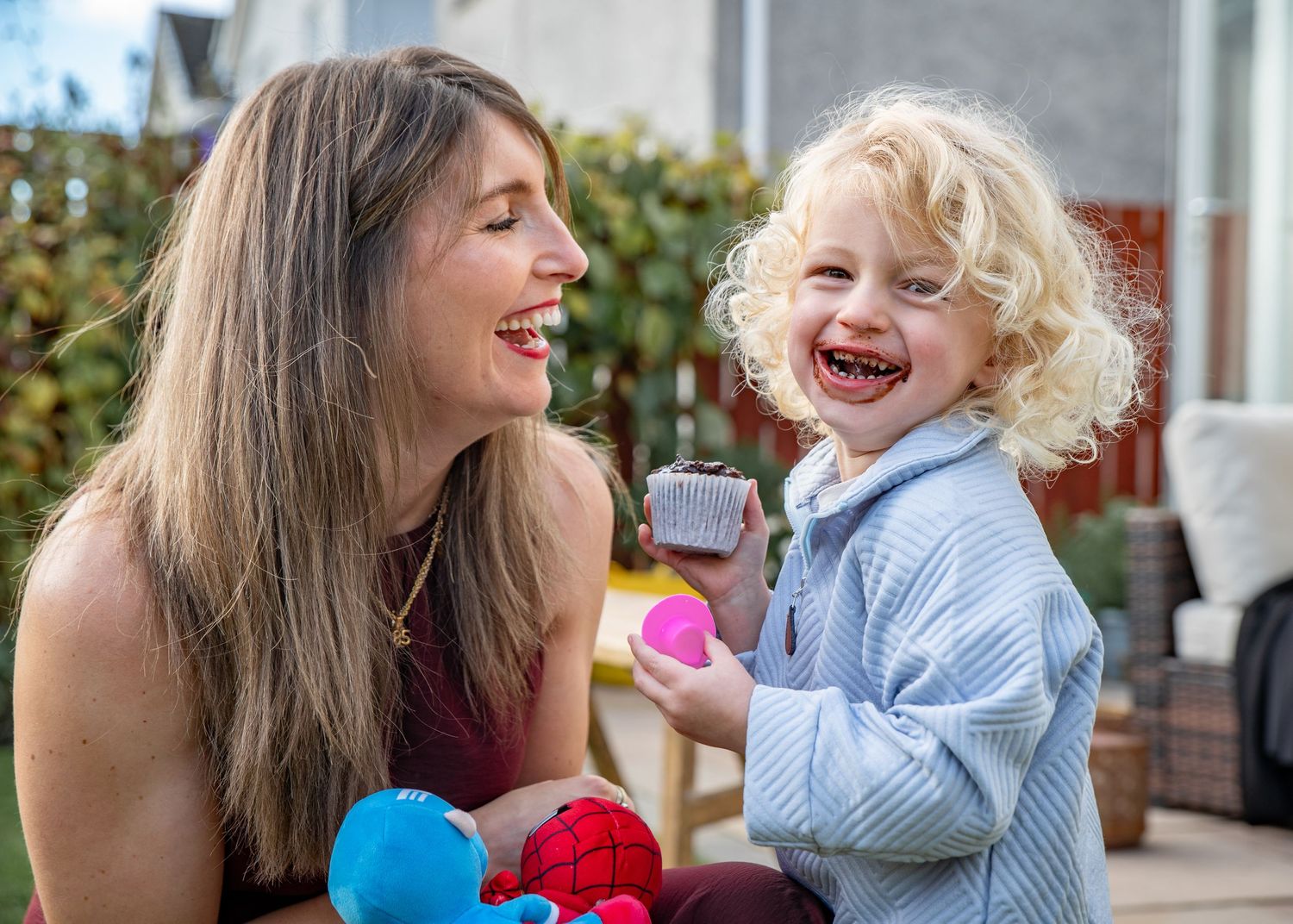 Joyful moments captured between parent and child playing together outdoors.