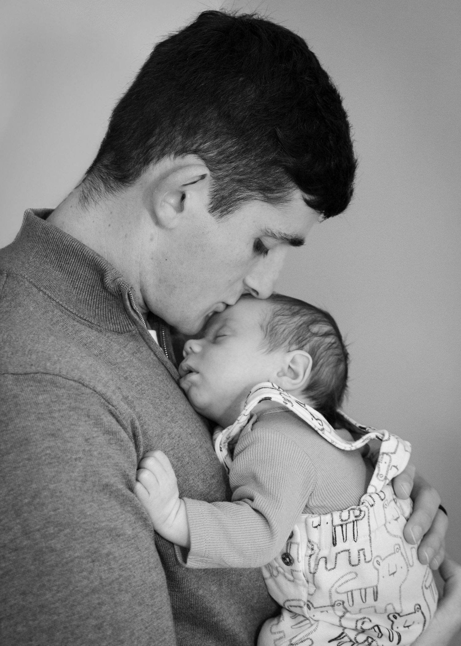 Black and white series showing tender moments between parent and infant.