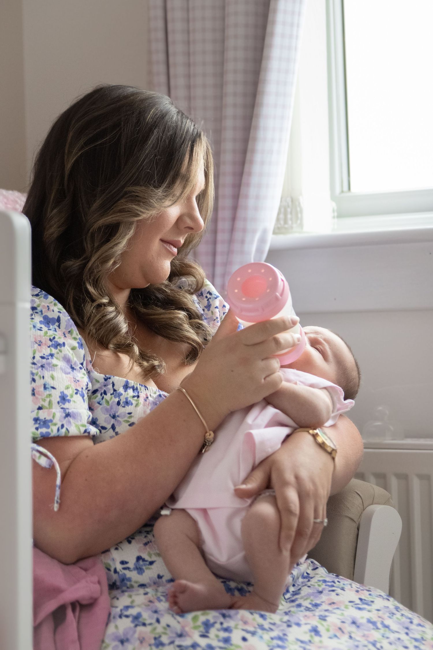 Tender moments captured between parent and baby in a sunlit bedroom.