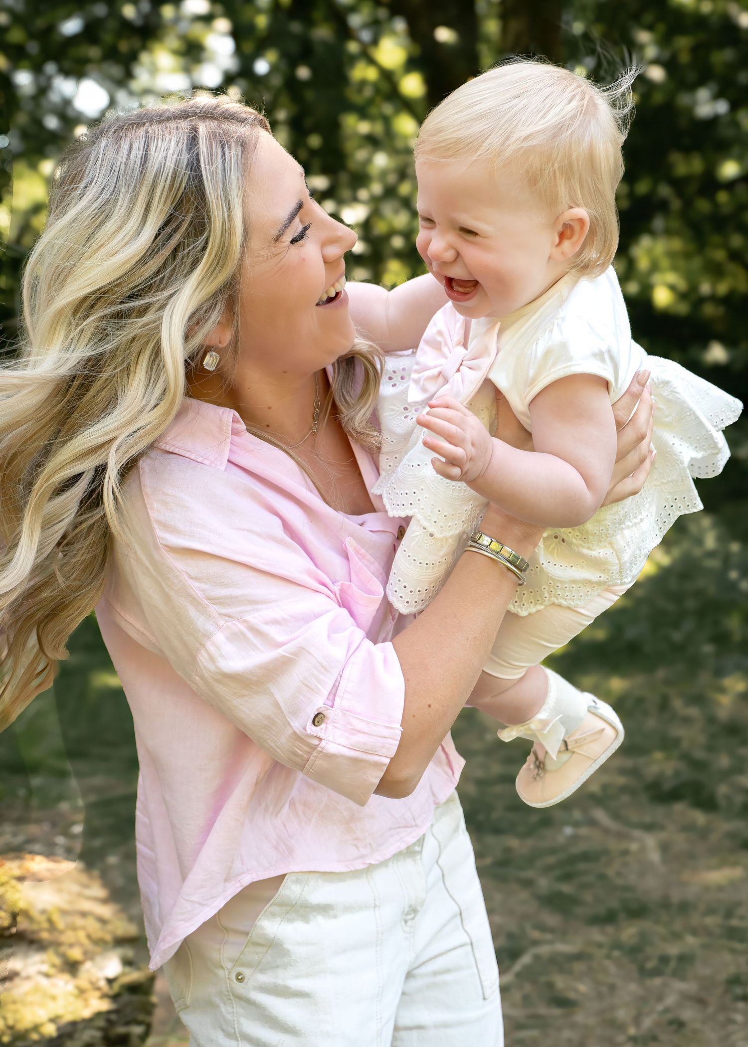 Joyful outdoor moment captured with laughter and embraces in natural sunlight.