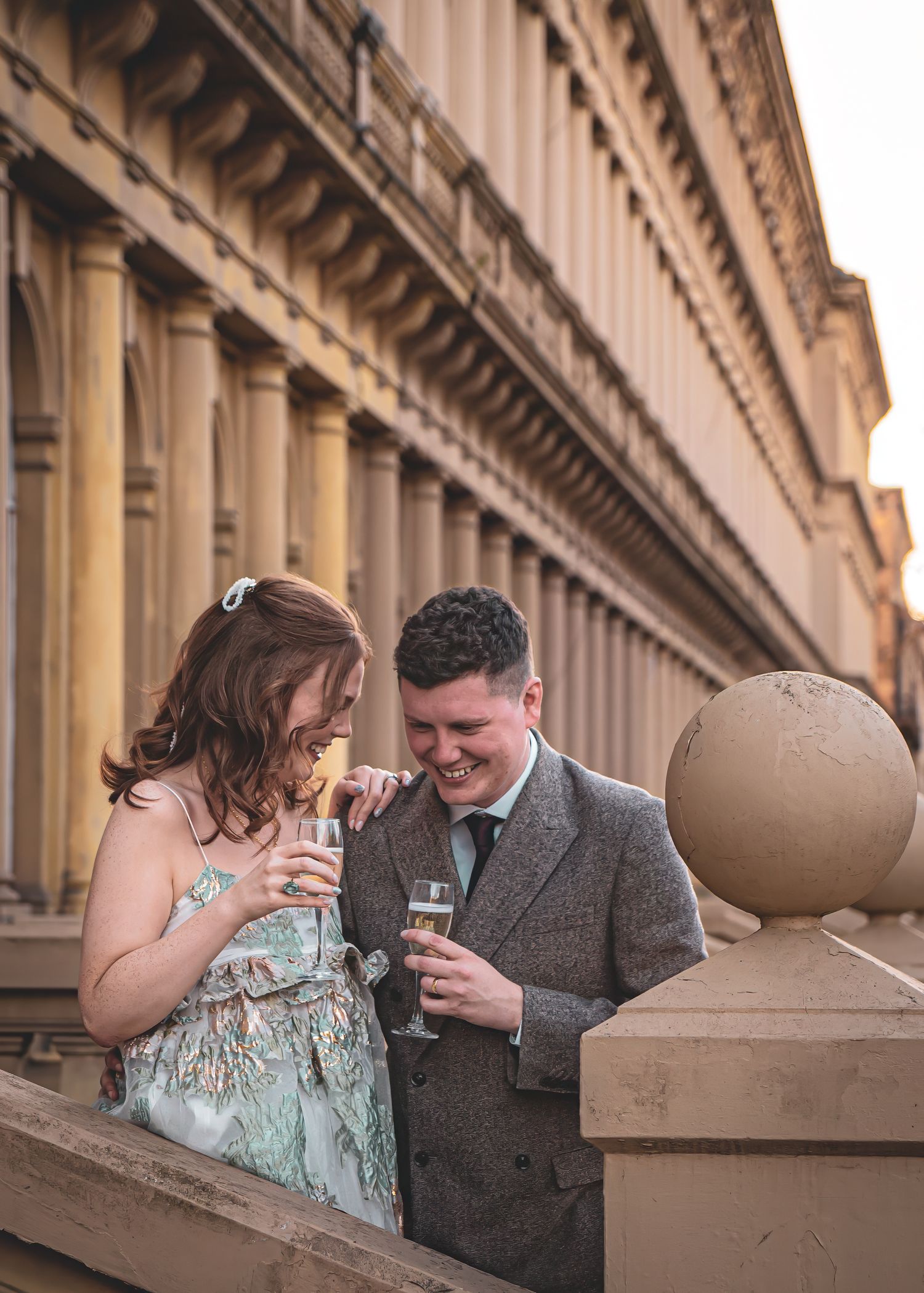 A couple shares intimate moments in a series of romantic photos against a classical architectural backdrop.