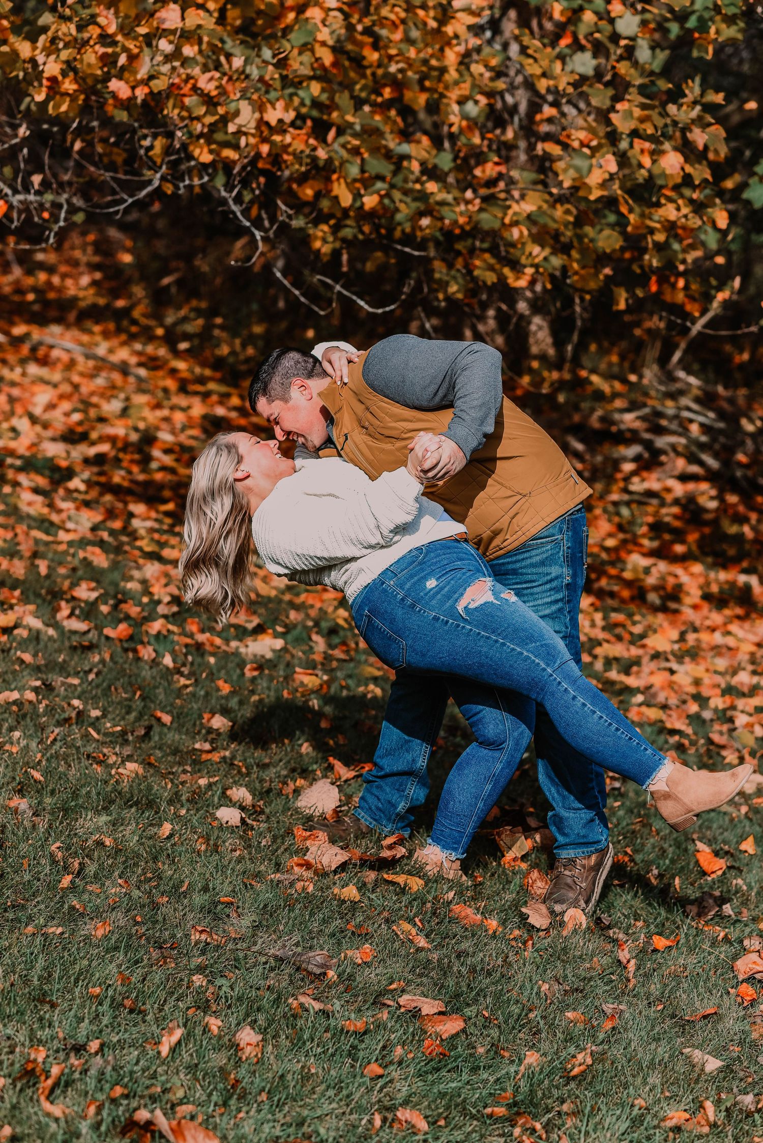 Romantic dip pose sequence in autumn setting with fallen leaves.