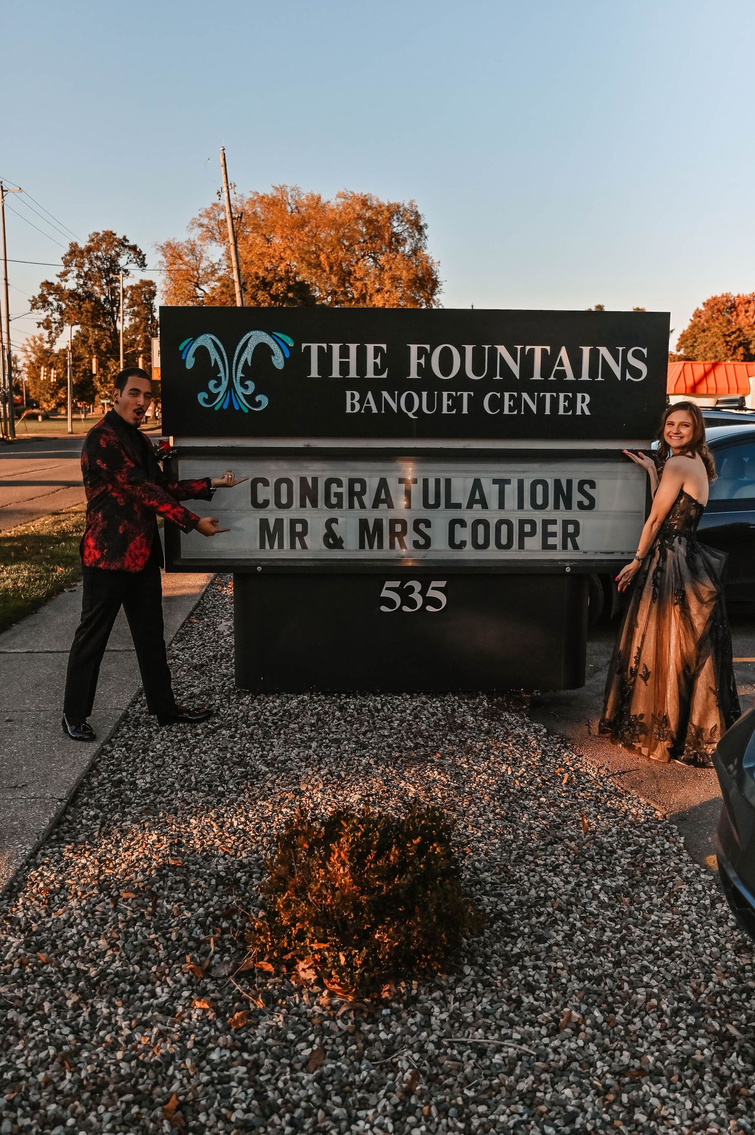 Venue sign for The Fountains Banquet Center at sunset.