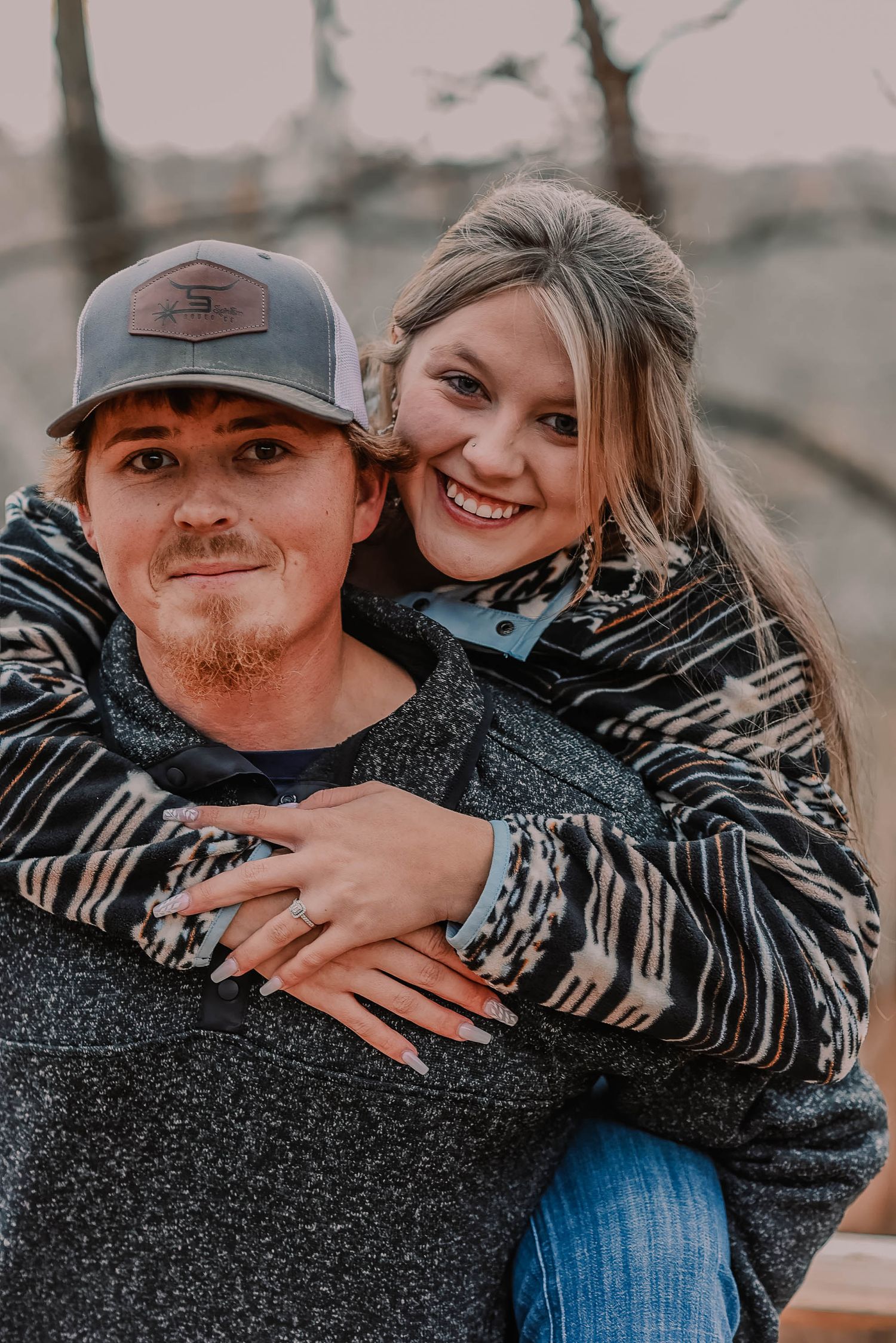 Playful couple in casual wear sharing intimate moments during fall photoshoot.