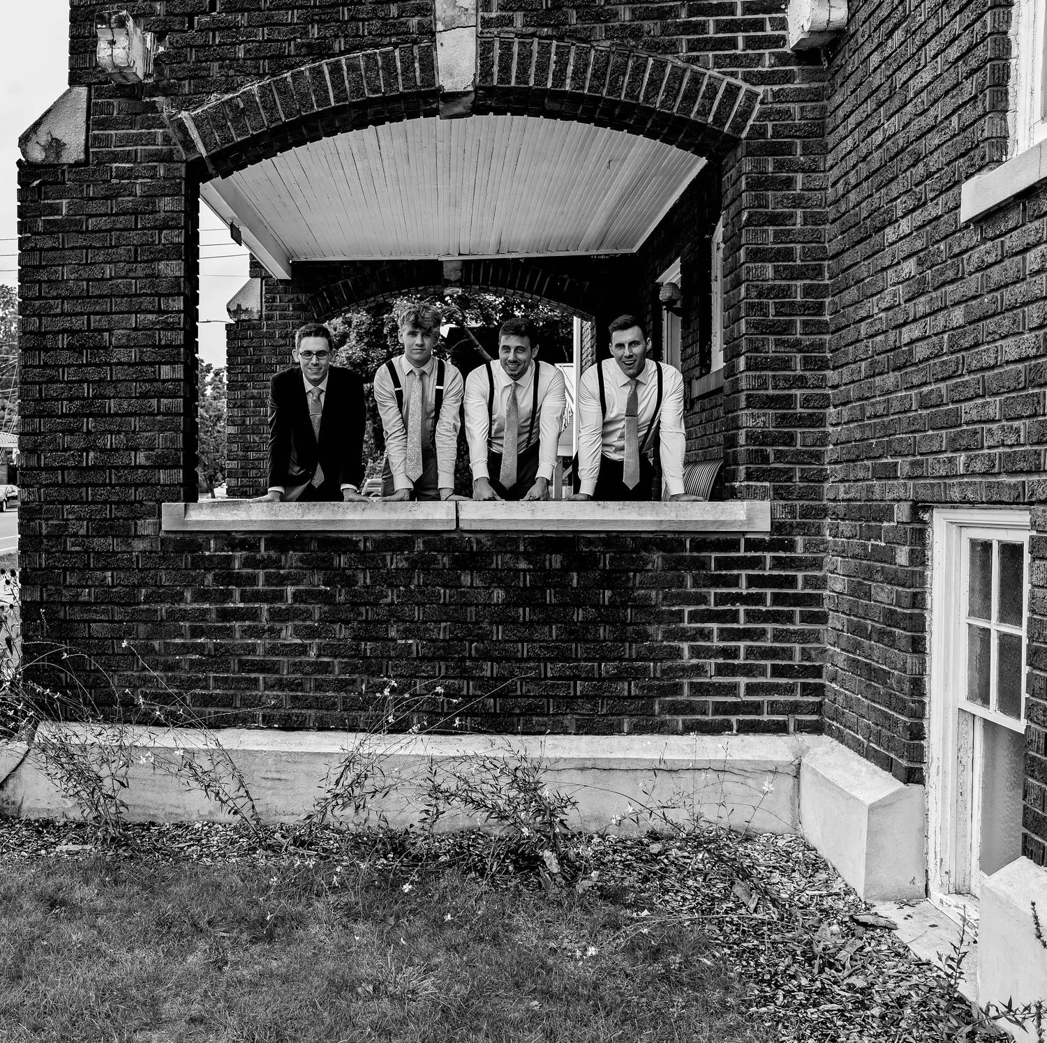 Wide architectural view of brick church entrance with covered porch.