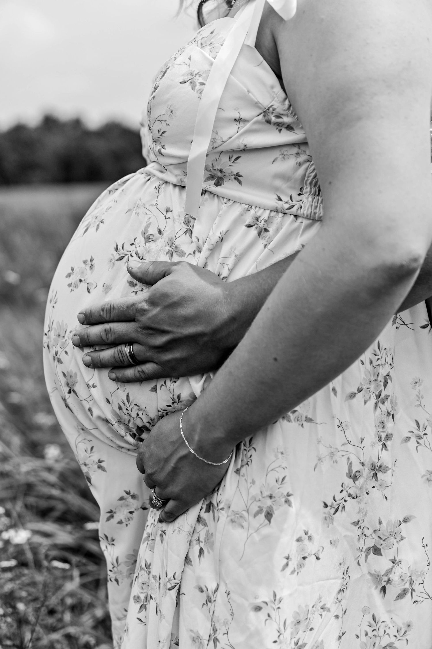 Close-up shots of a floral dress showing a growing baby bump during pregnancy.