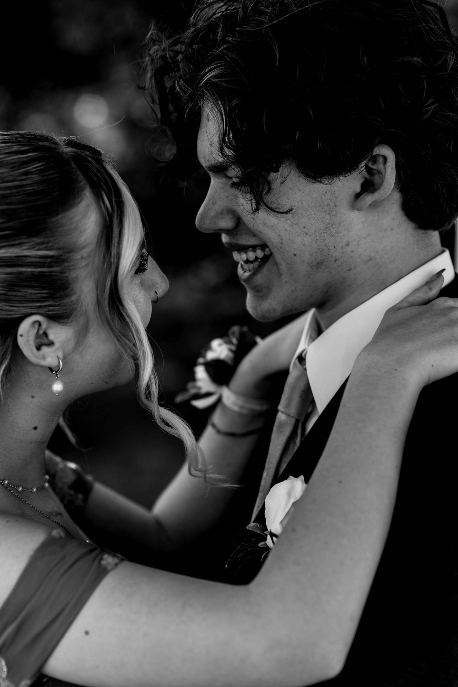 Romantic black and white wedding photo sequence showing intimate moments between newlyweds against dark background.