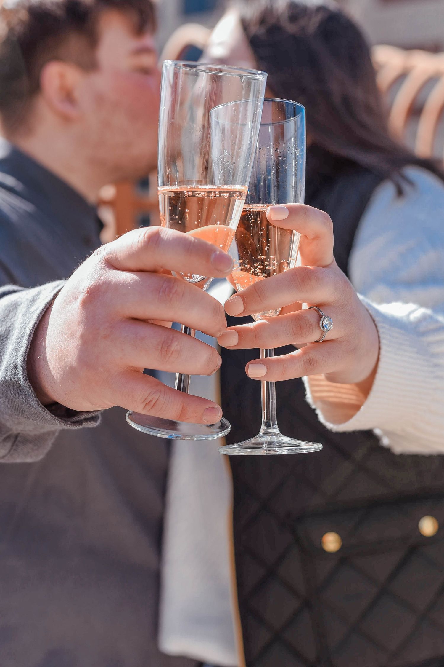 Close-up shots of hands toasting with champagne glasses in sequence.