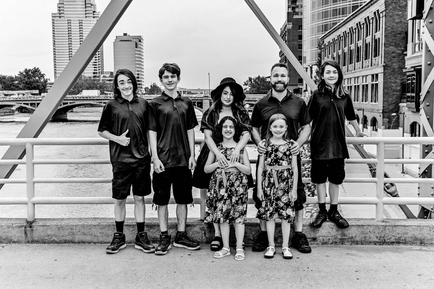 Black and white panoramic group photo on urban steps with architectural elements.