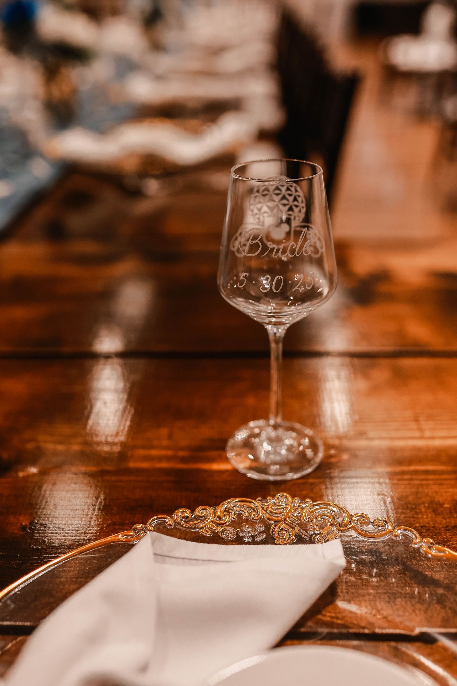 Elegant wine glasses on a wooden table with warm ambient lighting.