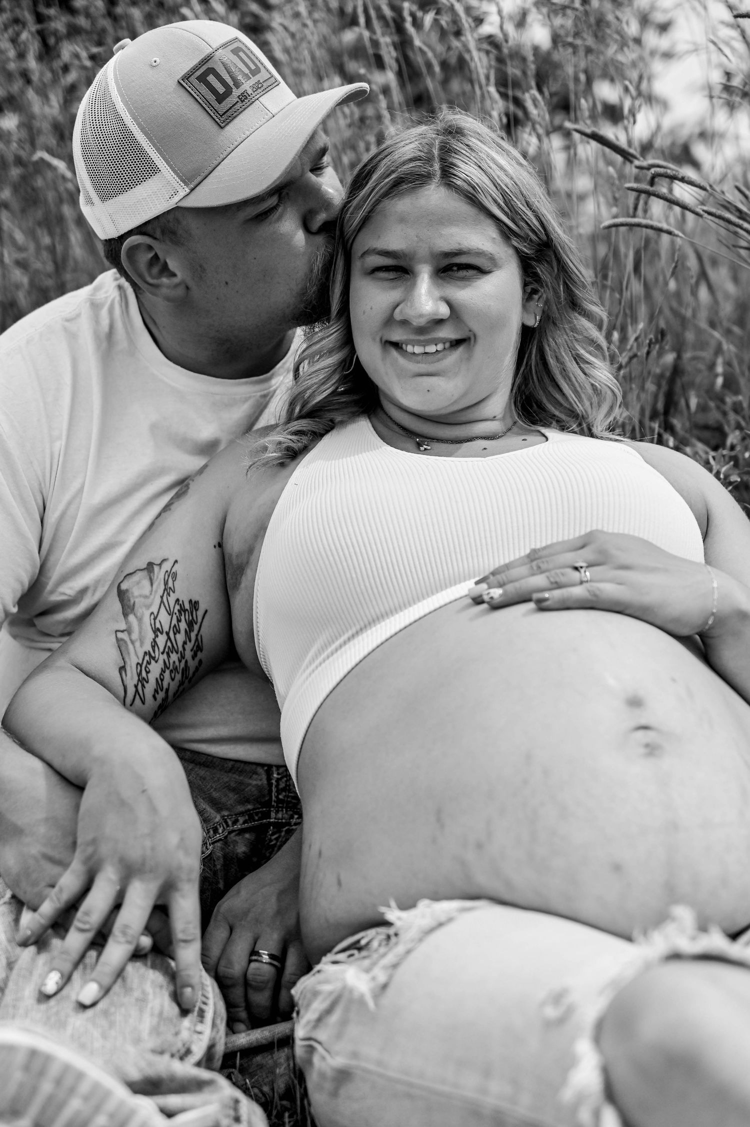 Black and white maternity photos capturing loving moments between expectant parents.