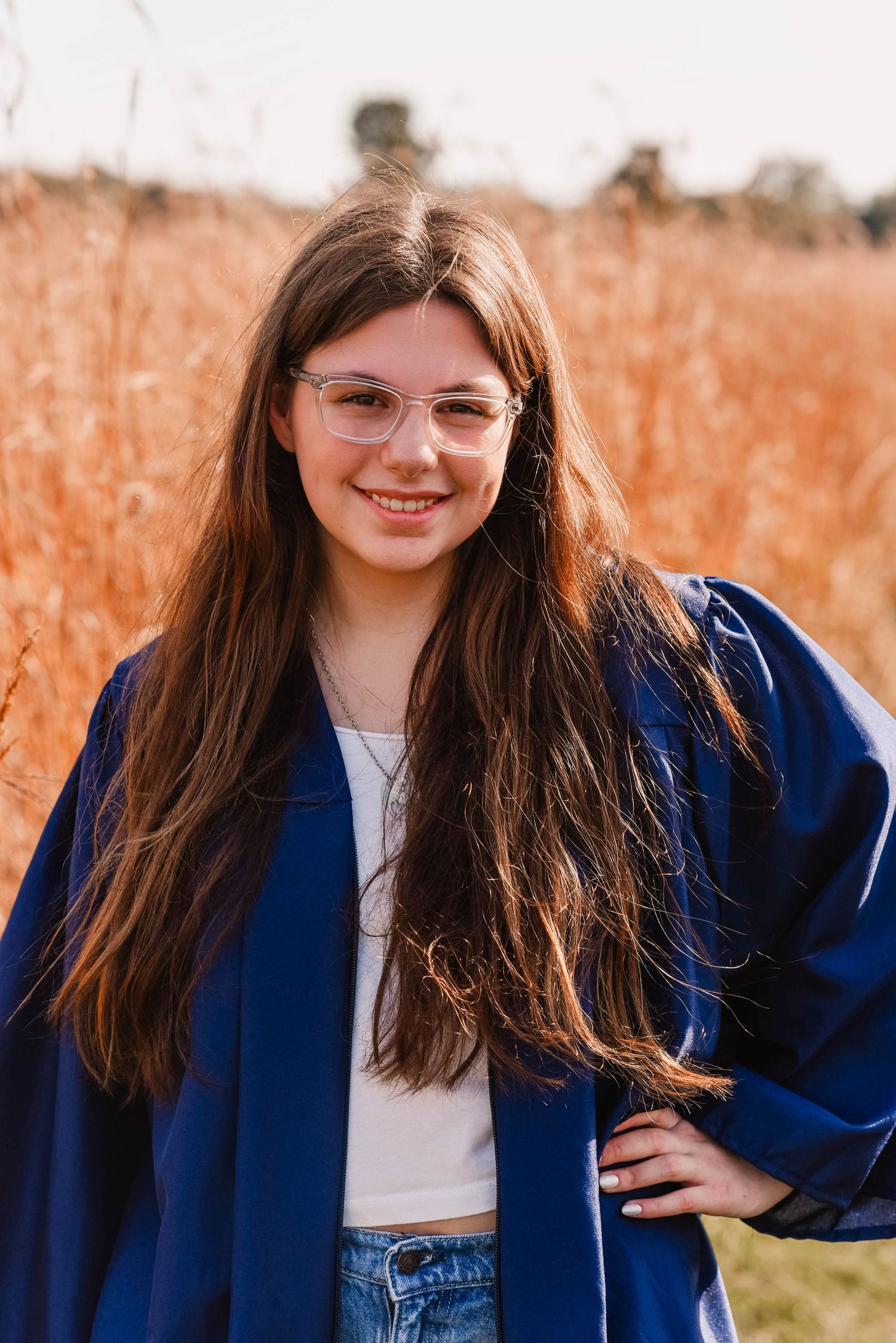 Portrait series in blue blazer and jeans against golden field background.