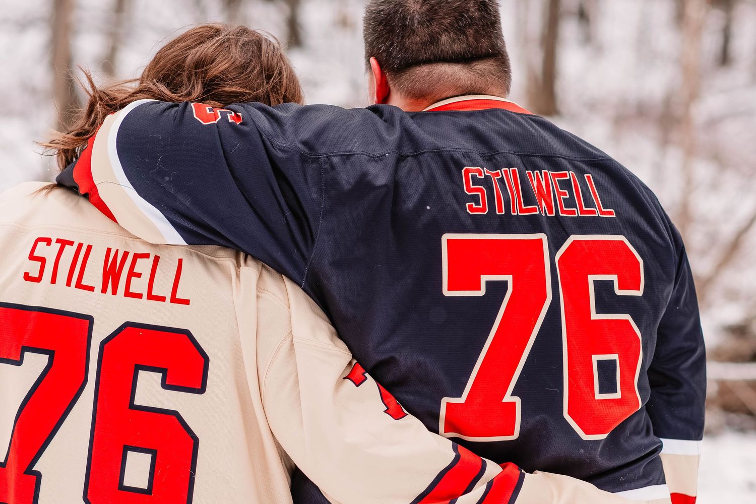 Row of red and white hockey jerseys with number 76 displayed in winter setting.