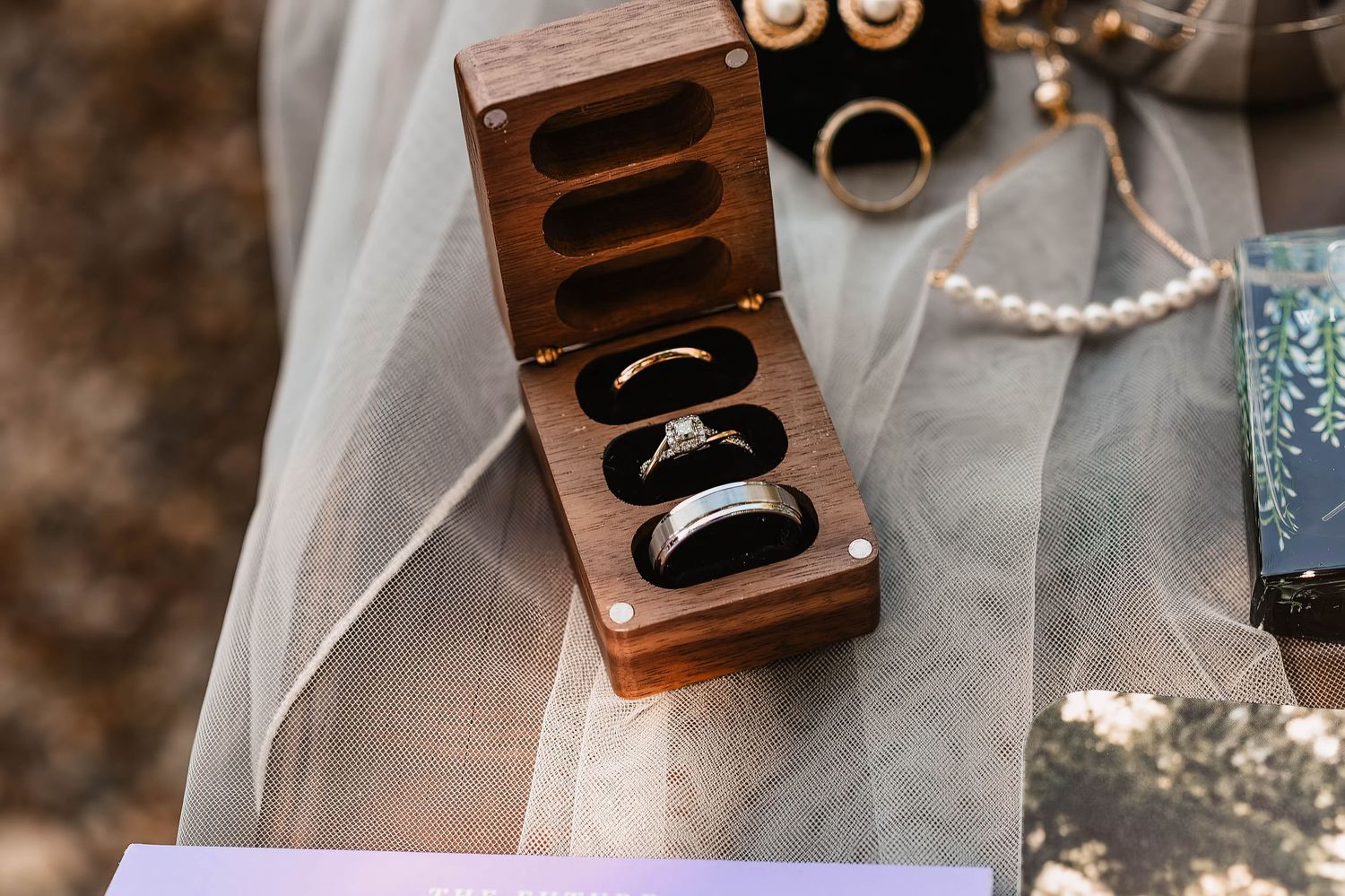 Vintage wooden ring boxes displayed with delicate wedding details and decorative elements.