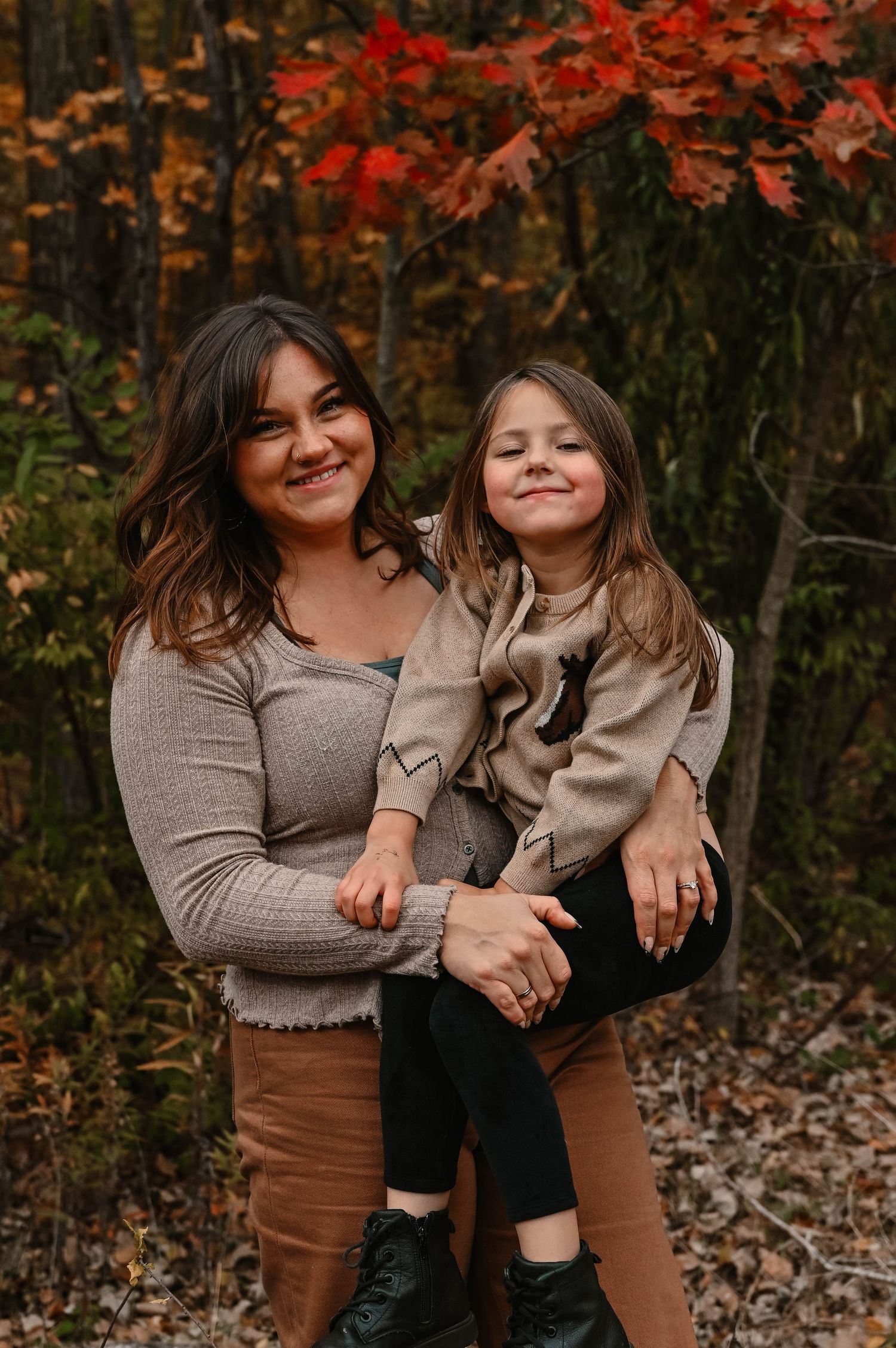 Joyful moments shared during an autumn photo session with fallen leaves.