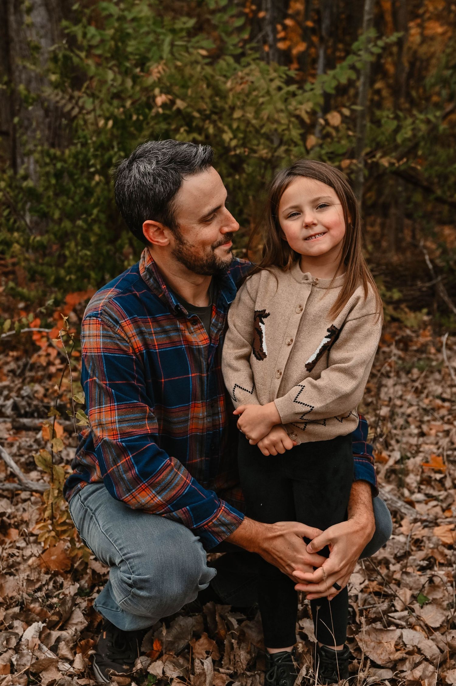 Intimate outdoor photo session in a forest setting with autumn colors.