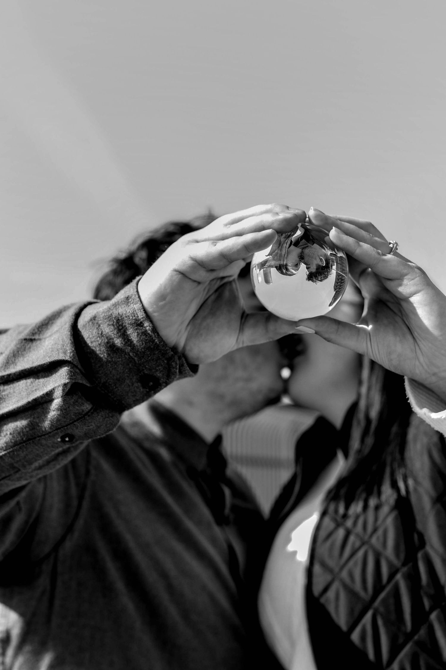 Black and white sequence showing hands forming a heart shape gesture.