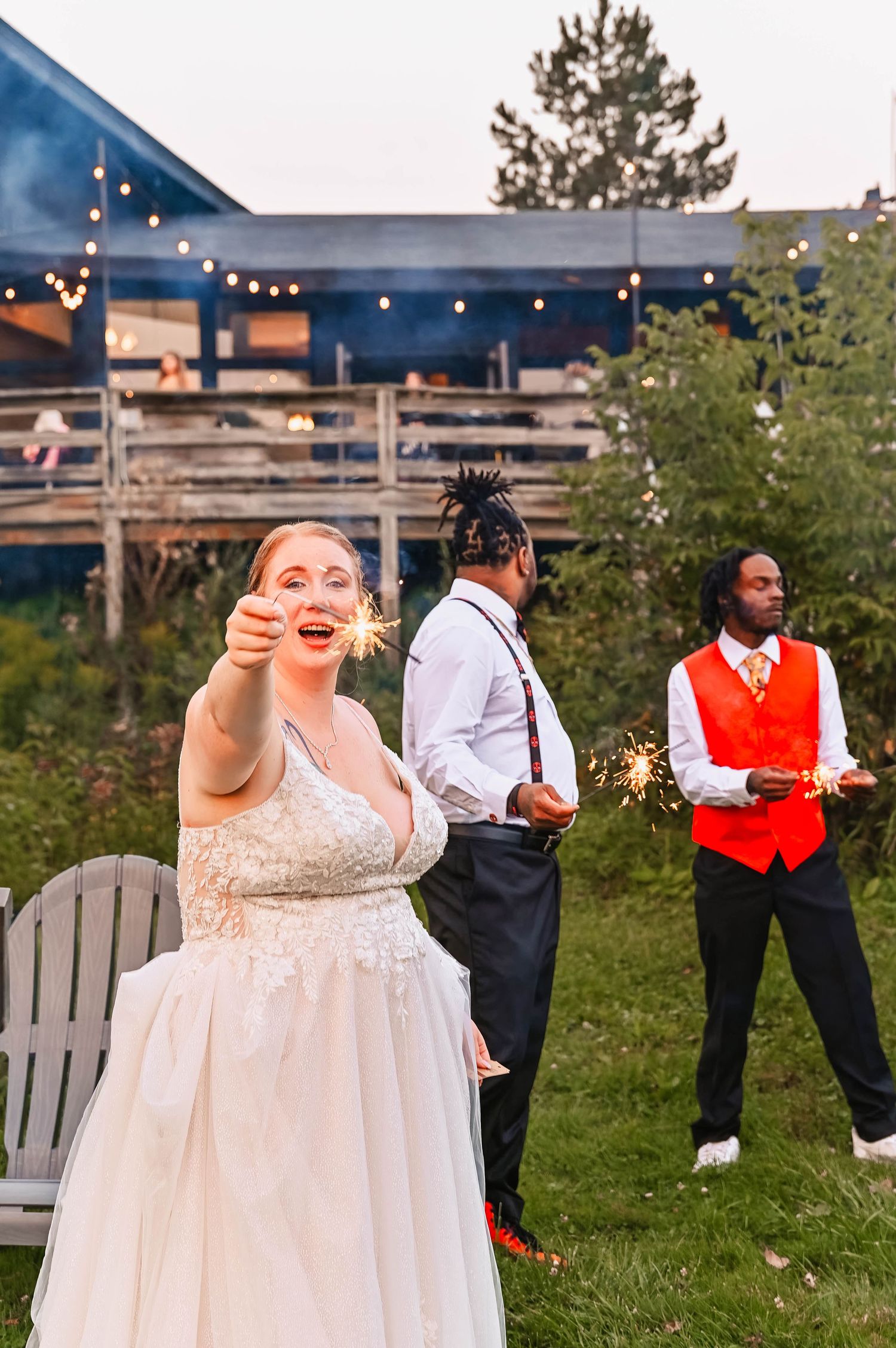 Wedding celebration at outdoor venue with string lights and festive atmosphere.