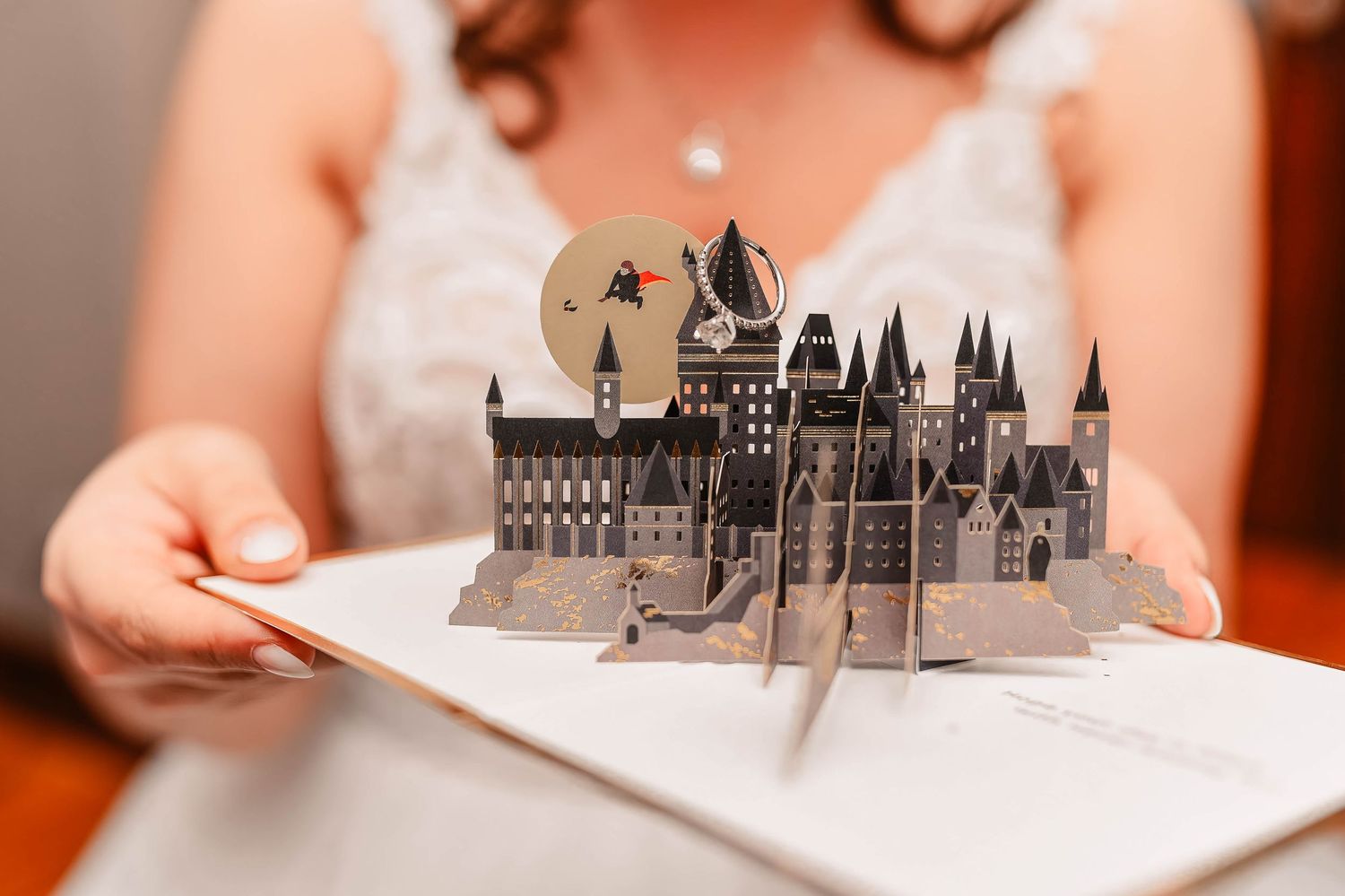 Miniature castle decorations displayed on white surface at wedding reception.