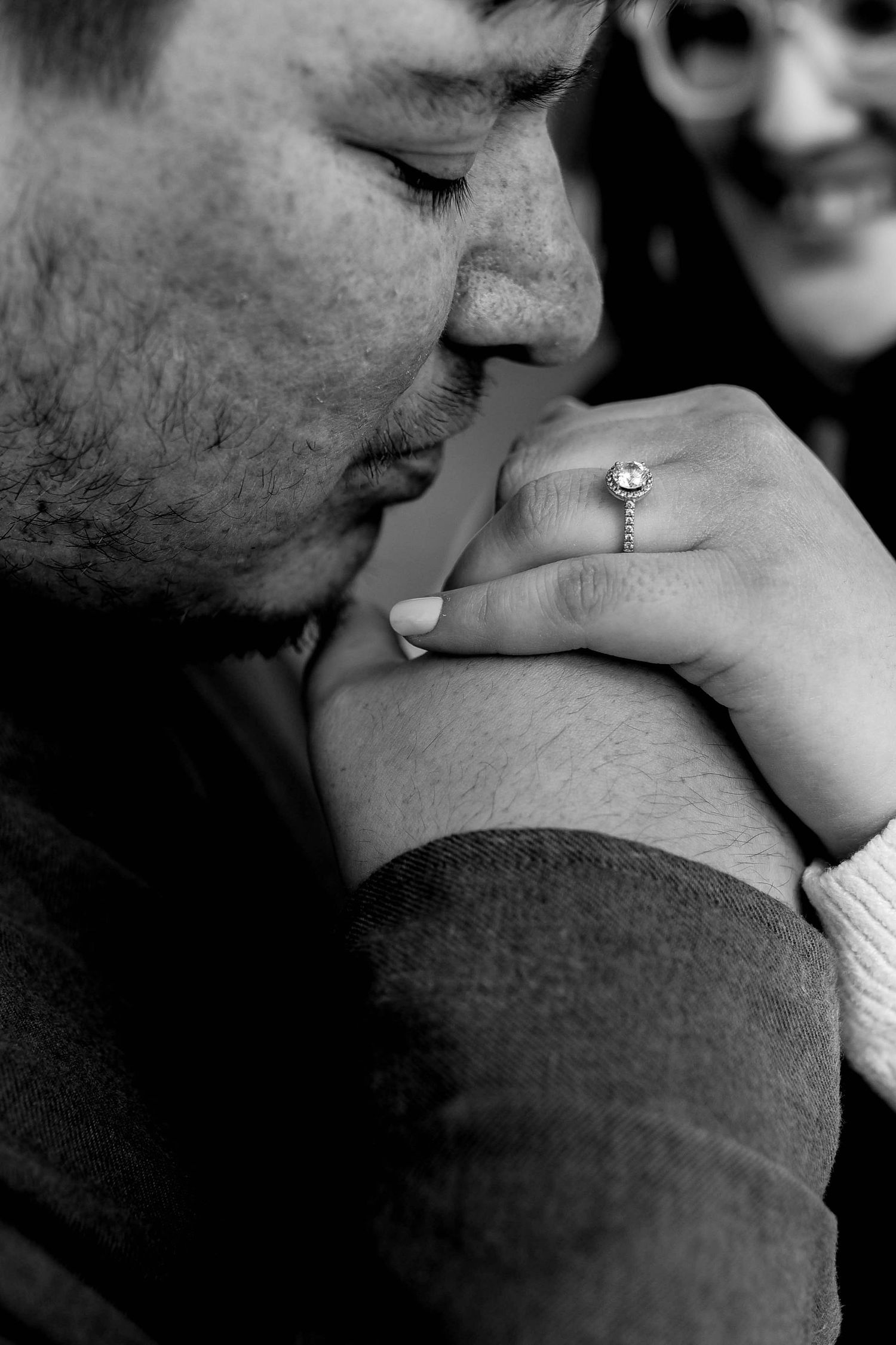 Close-up black and white intimate portrait showing tender affection between two people.