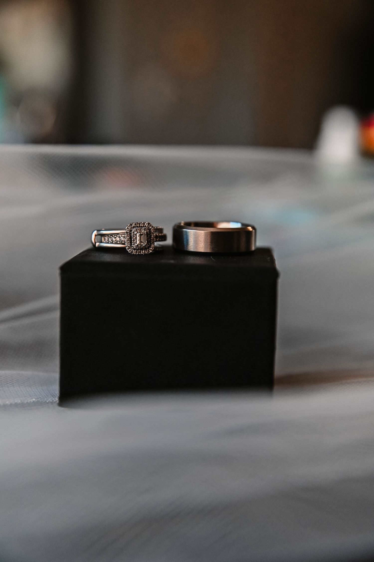 Wedding rings displayed on a black velvet surface with soft focus.