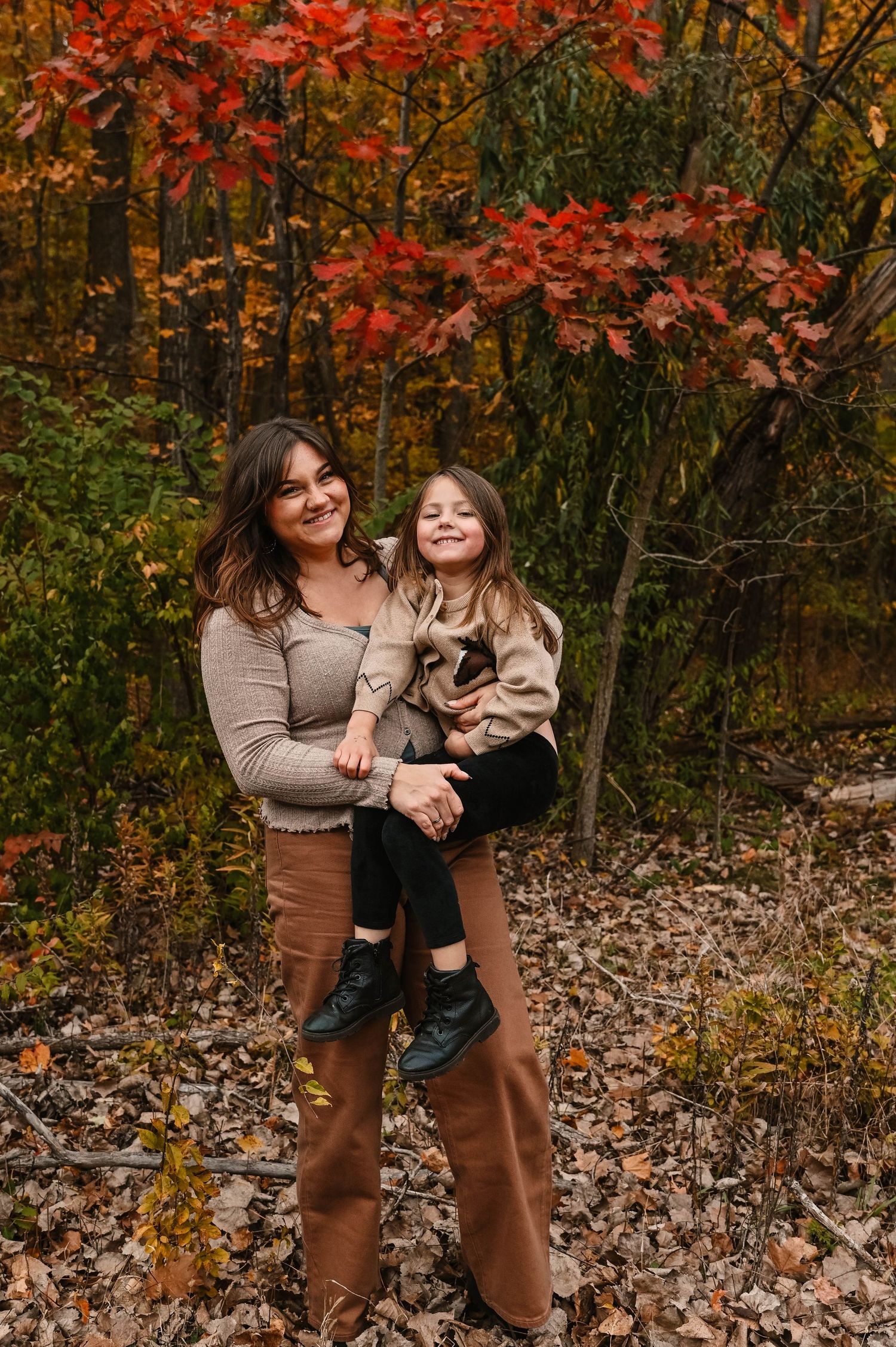 Candid autumn photography session with warm earth tones and falling leaves.