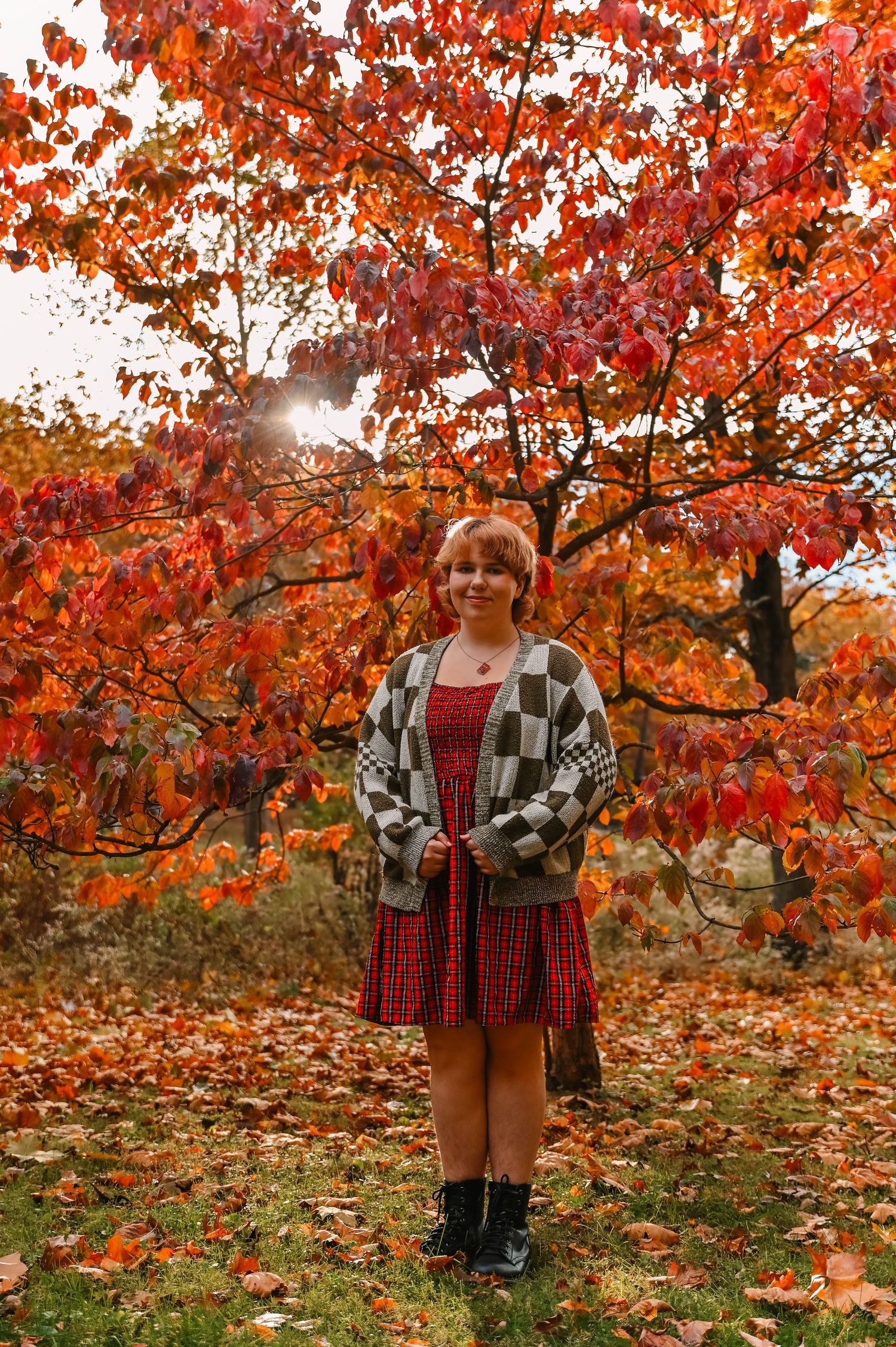 Vibrant red maple trees create a stunning backdrop for an autumn photoshoot.