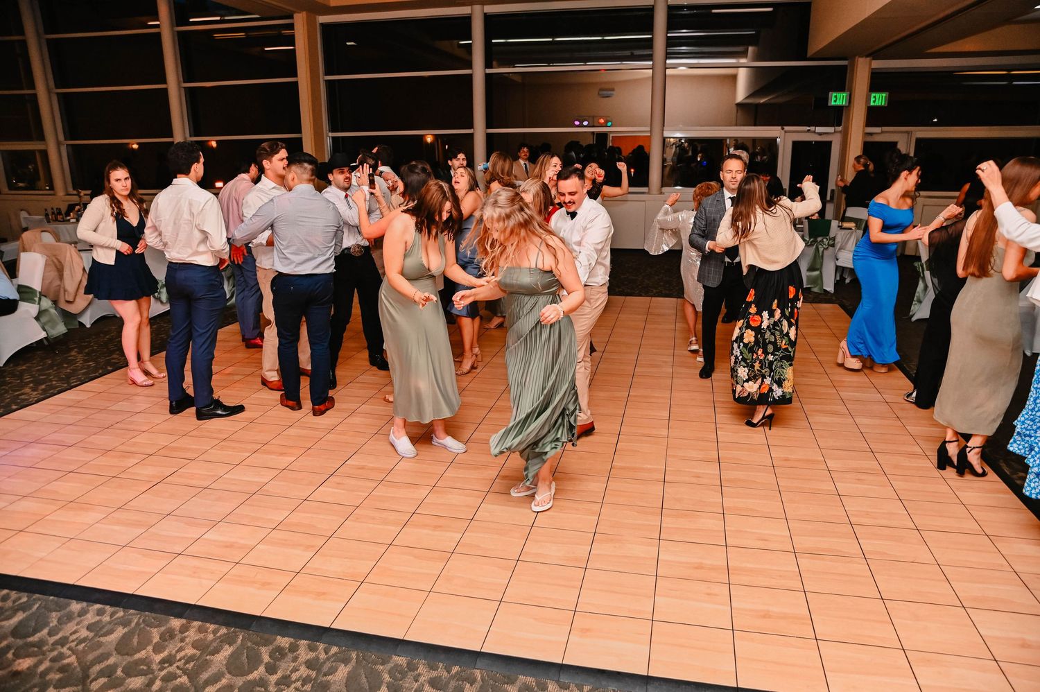 Wedding reception dance floor filled with guests enjoying the celebration.